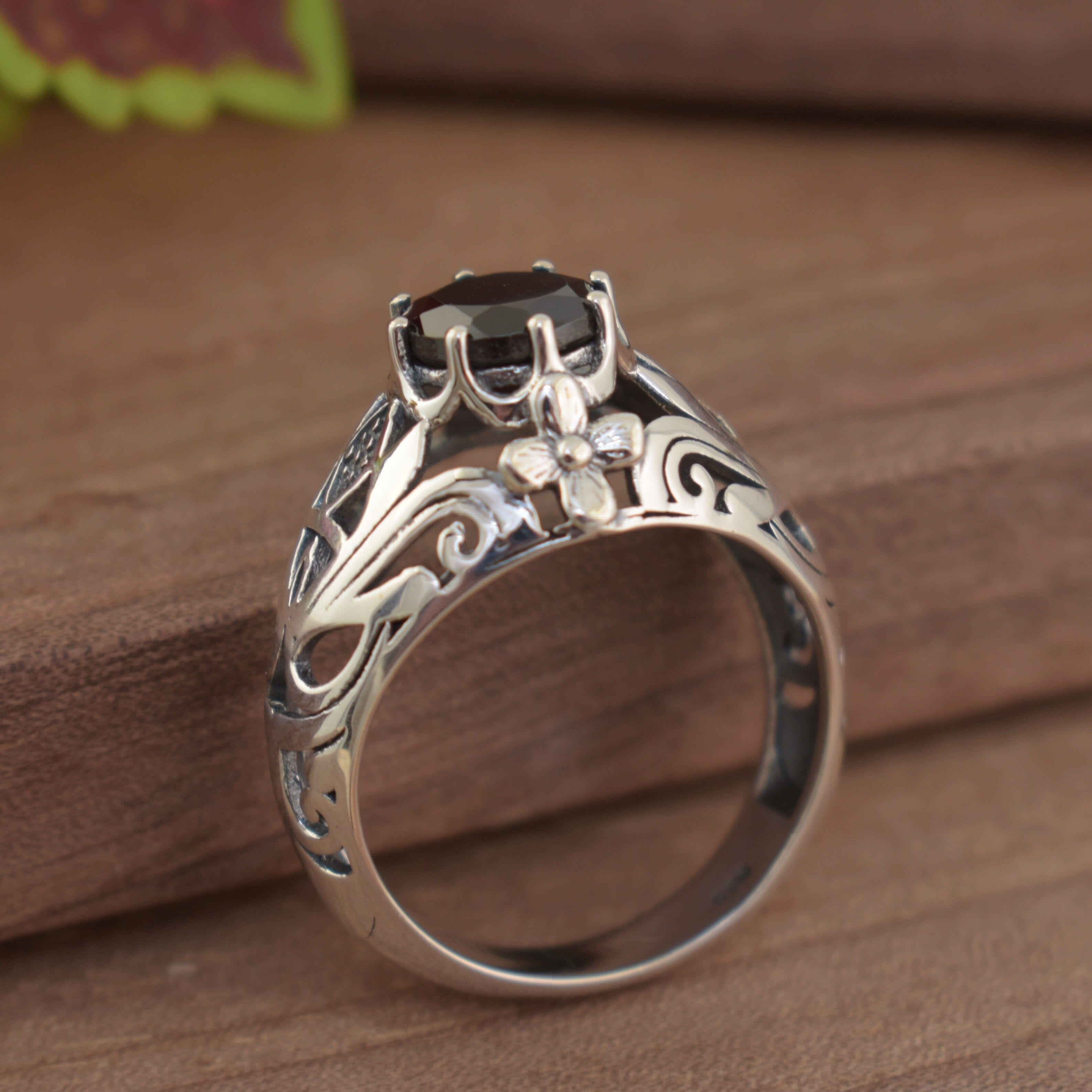 statement ring with a flower cut out design on the band