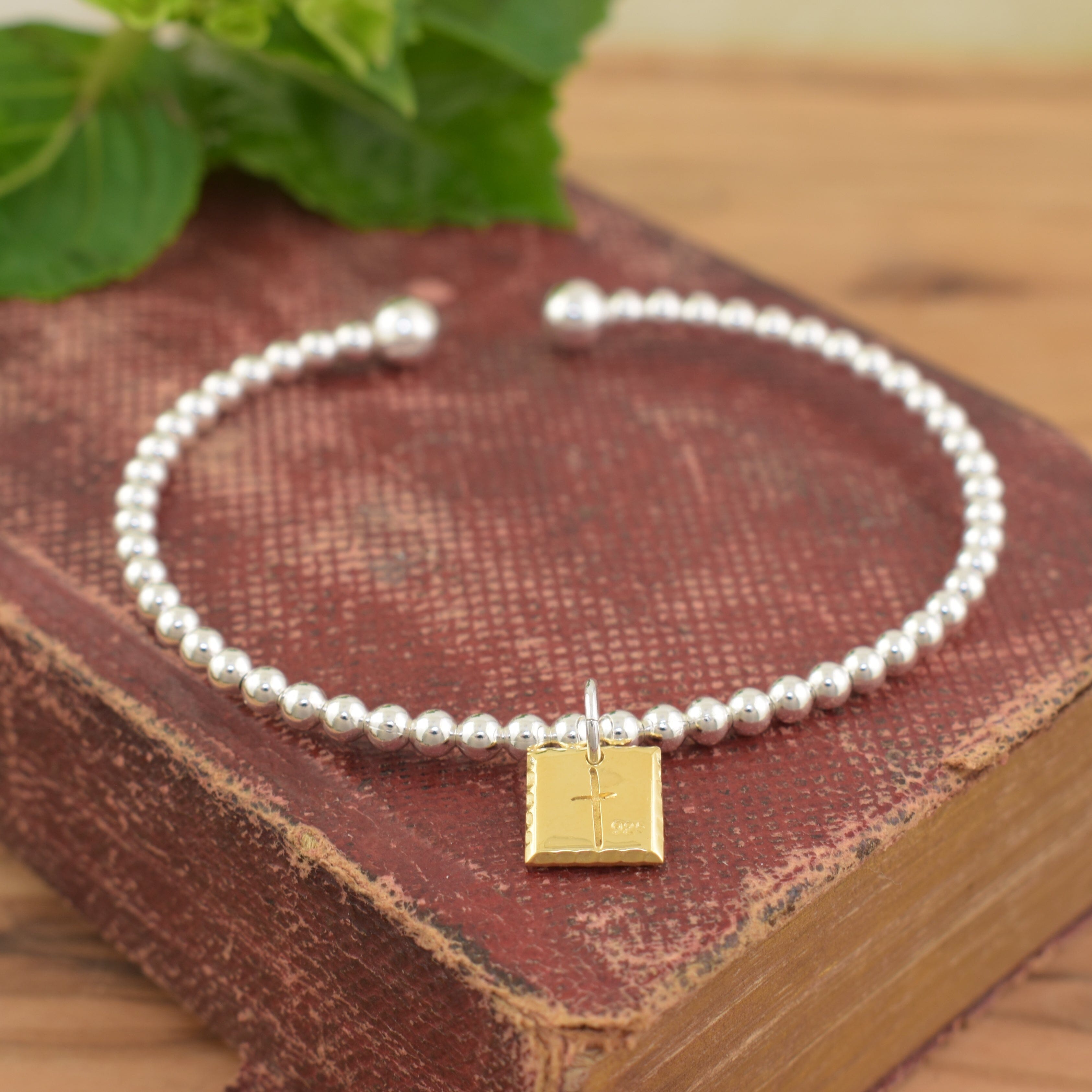 engraved 41 cuff bracelet in sterling silver and gold plating with a cross on the back of the pendant