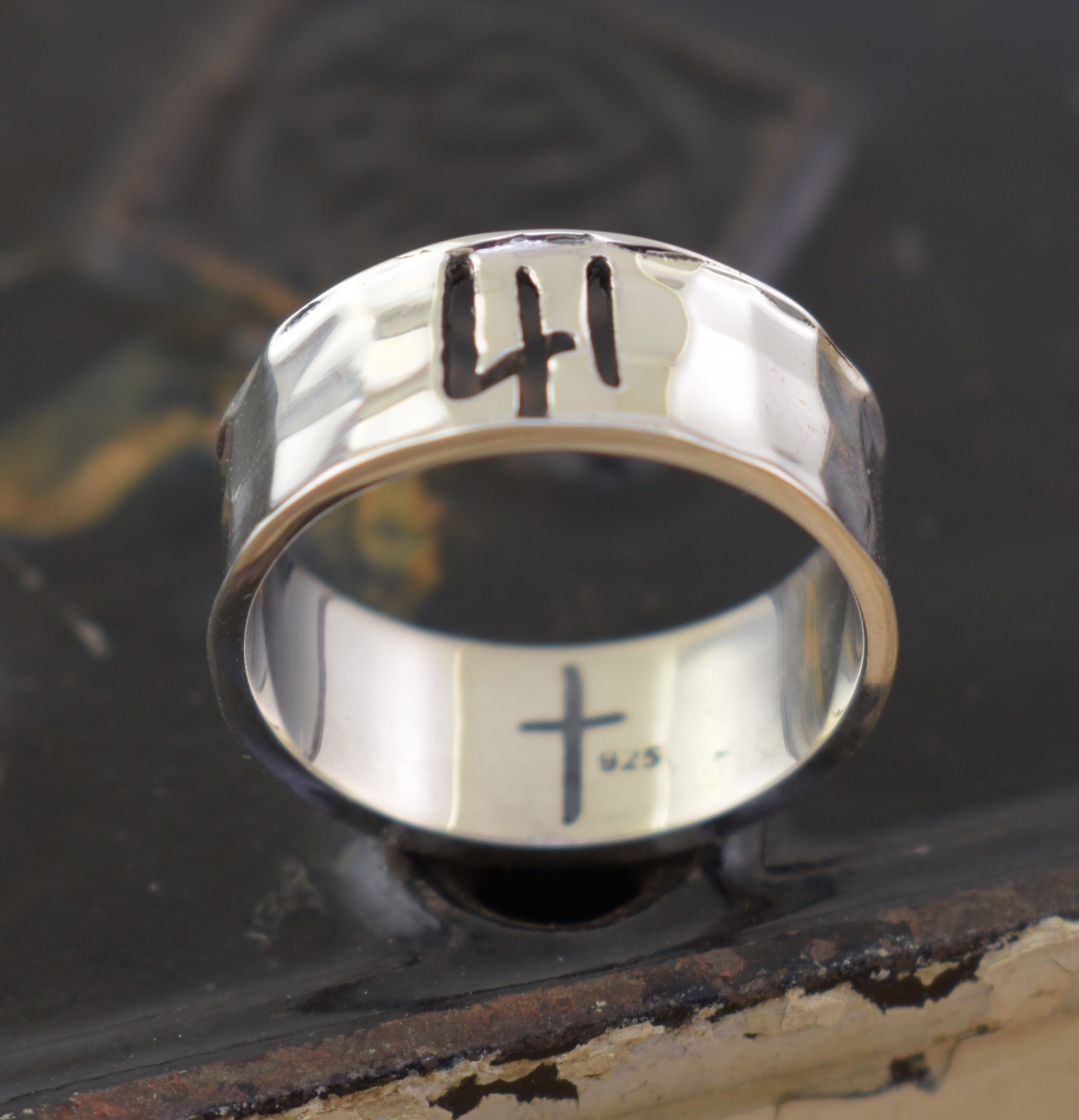 hand crafted sterling silver band ring with 41 cut out and a cross on the inside