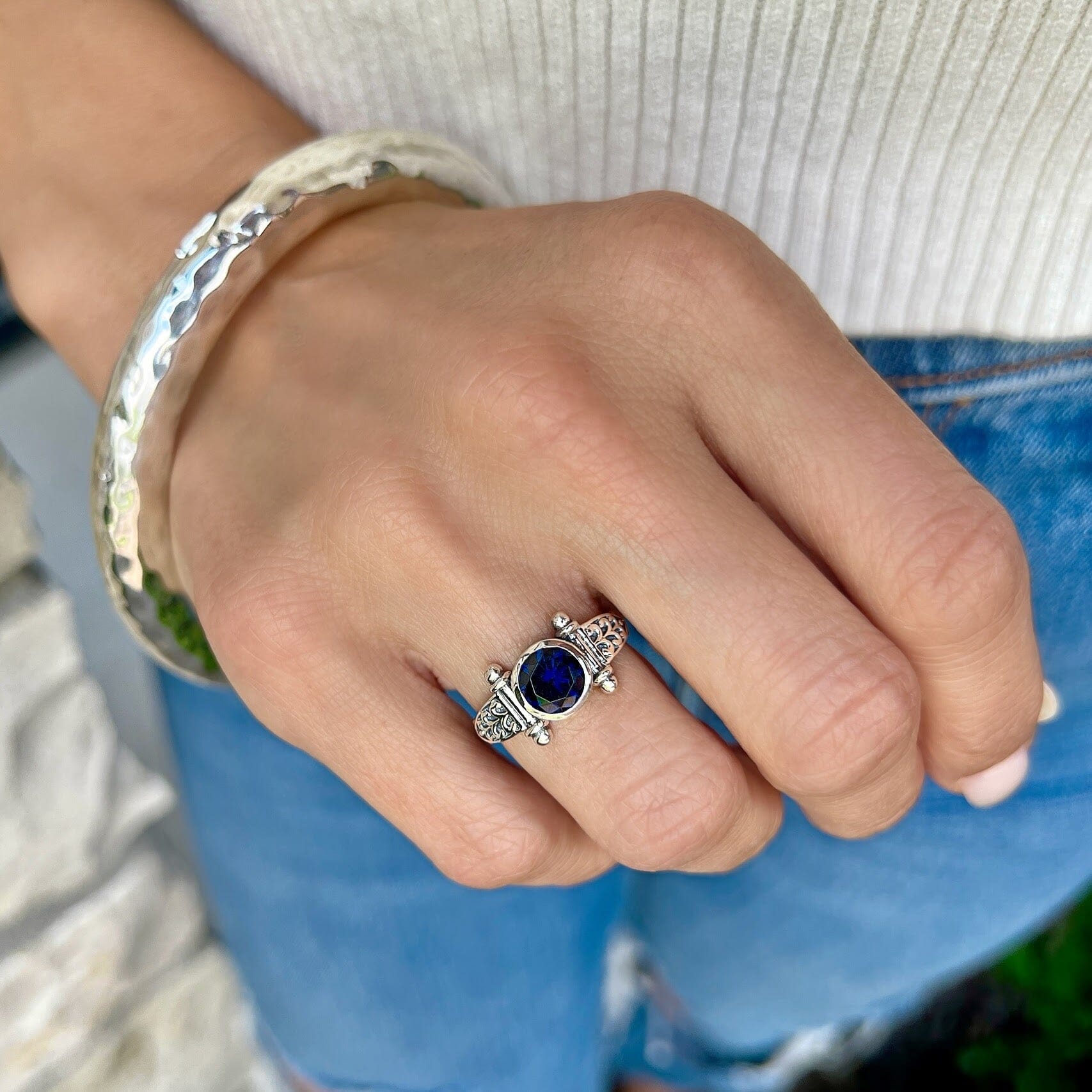 sterling silver designed ring featuring a blue cz stone paired with the hammered bliss bangle