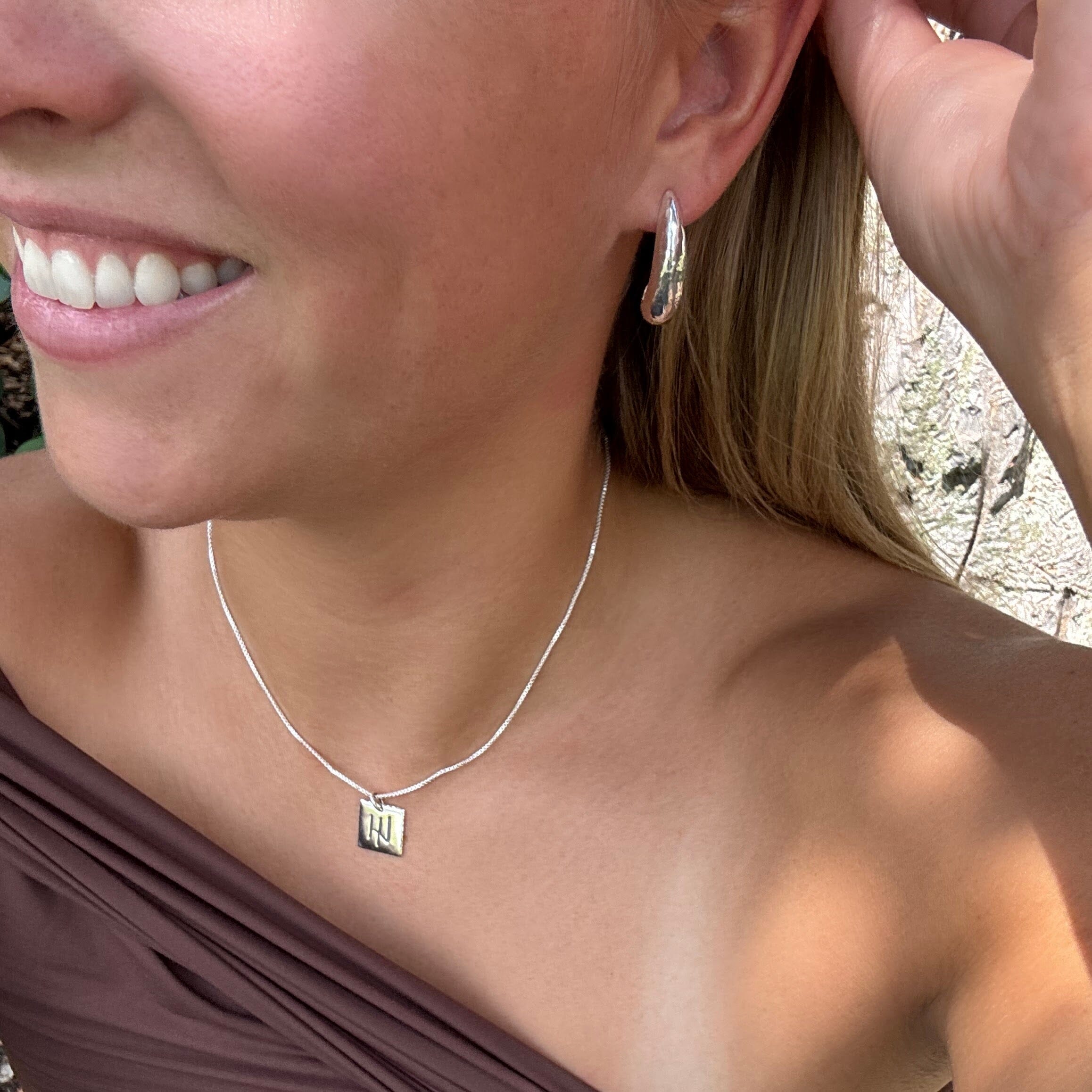 push-back post silver earrings with a sleek curve design