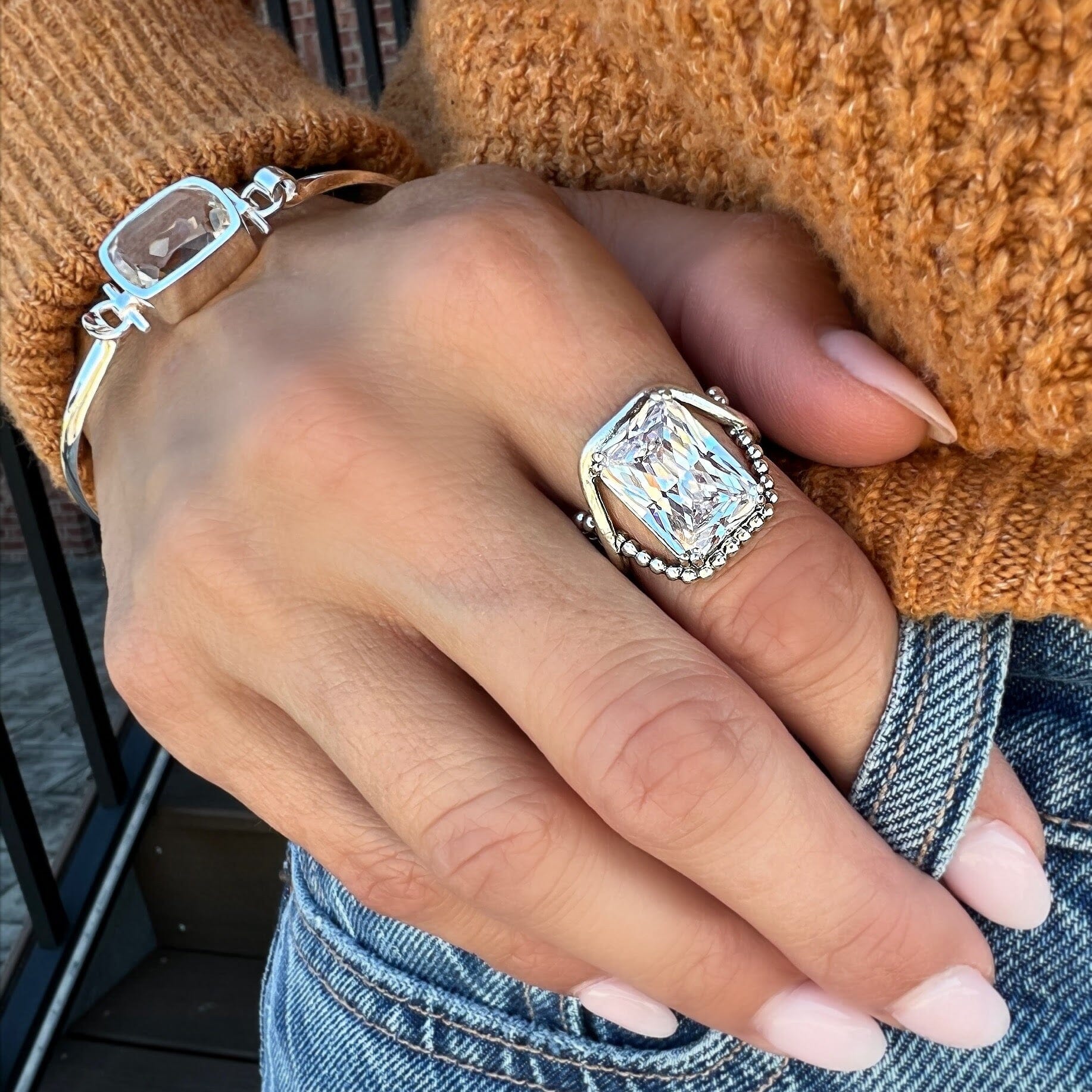 unique chunky ring featuring a crossing beaded band and a solid silver band with a CZ stone
