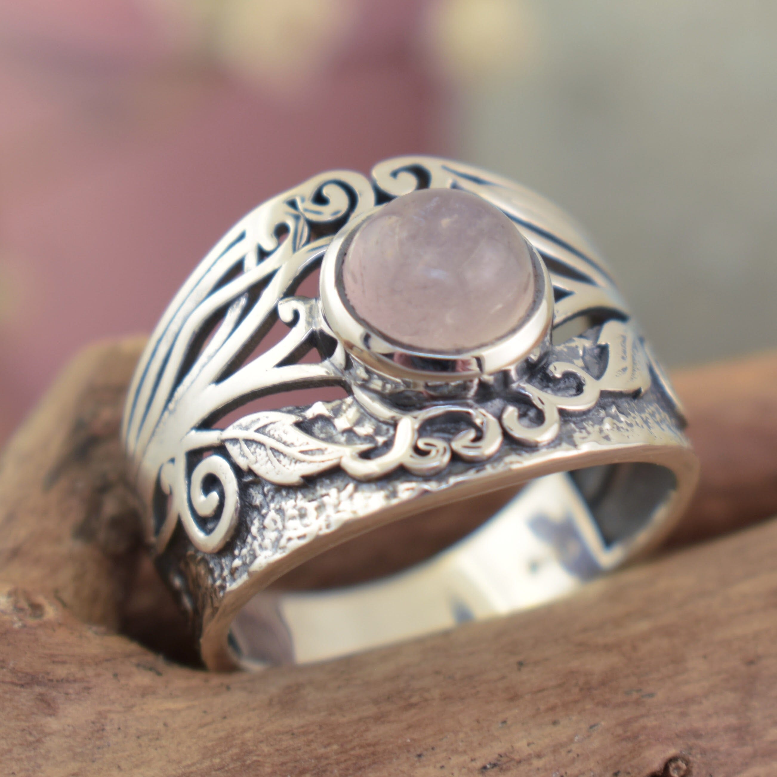 swirl and leaf motif ring with center rose quartz stone