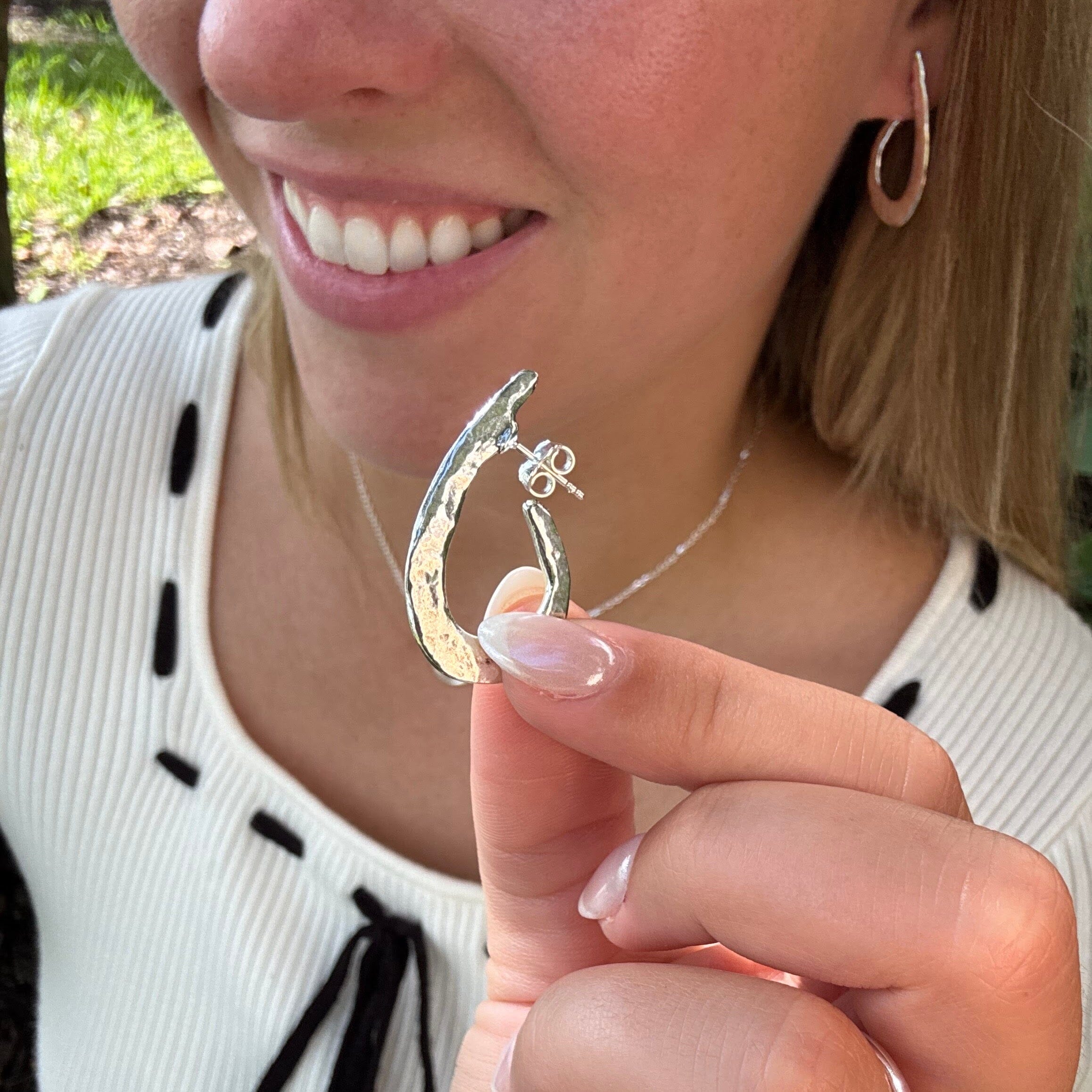 silver curved push-back post earrings with a hammered finish