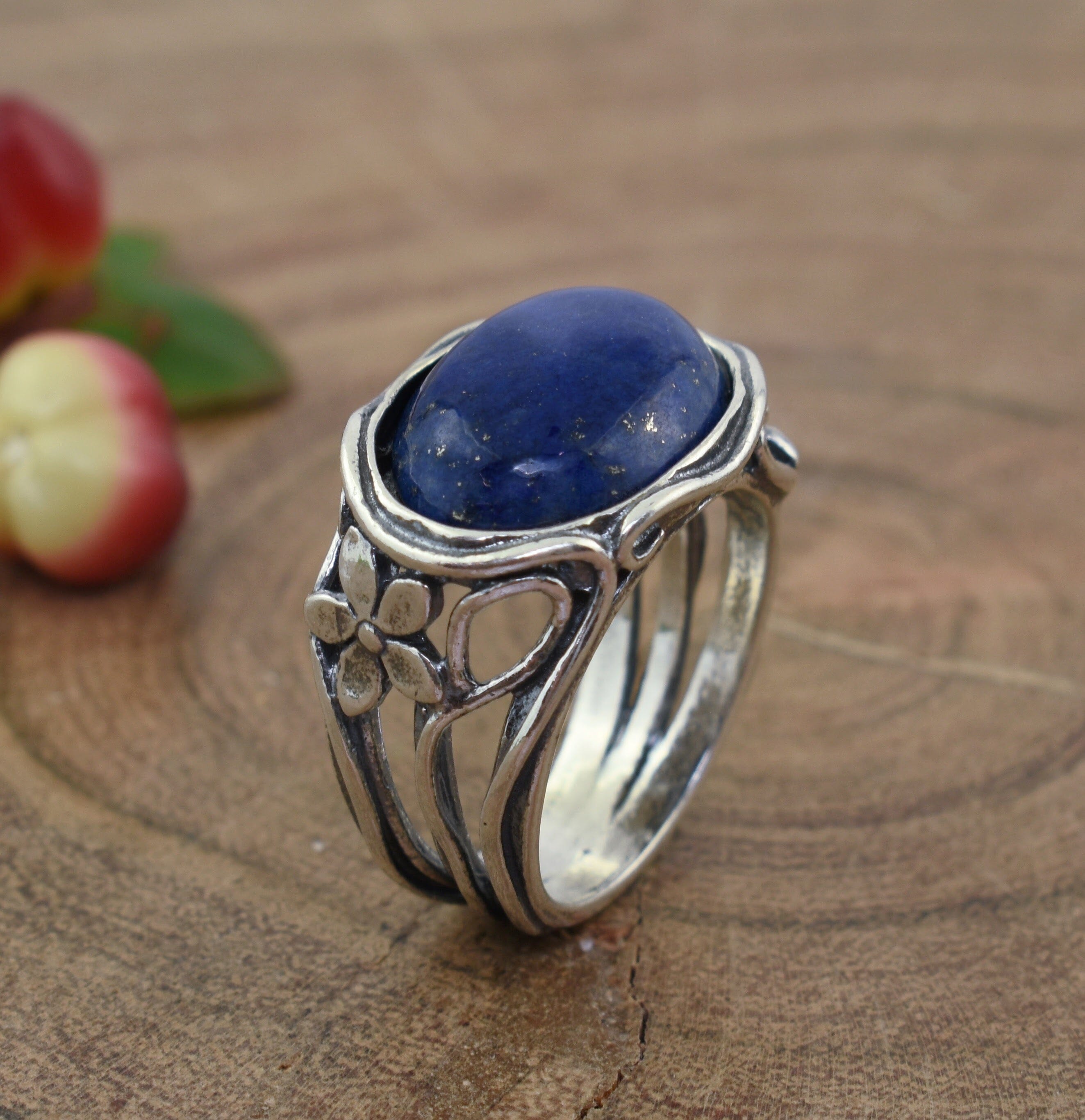 Sterling silver ring with floral detail band and lapis blue stone