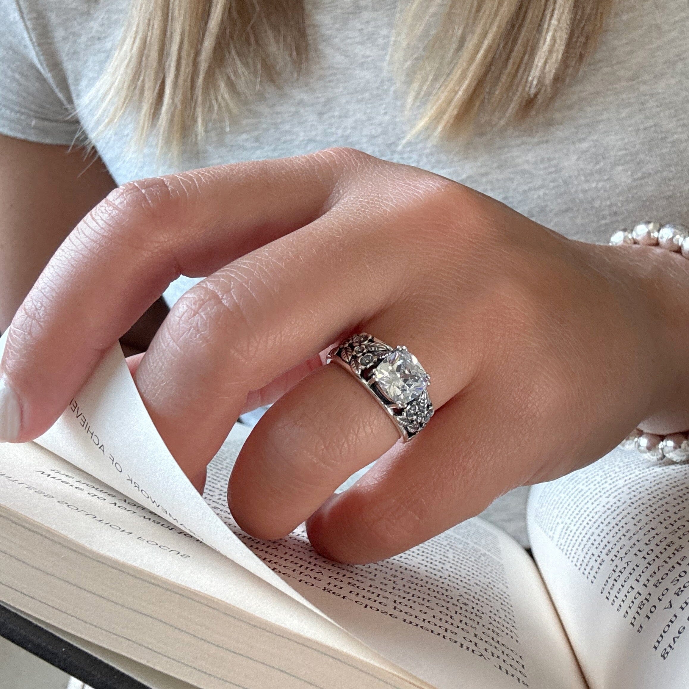 cz flower ring with an oxidized and high polished finish