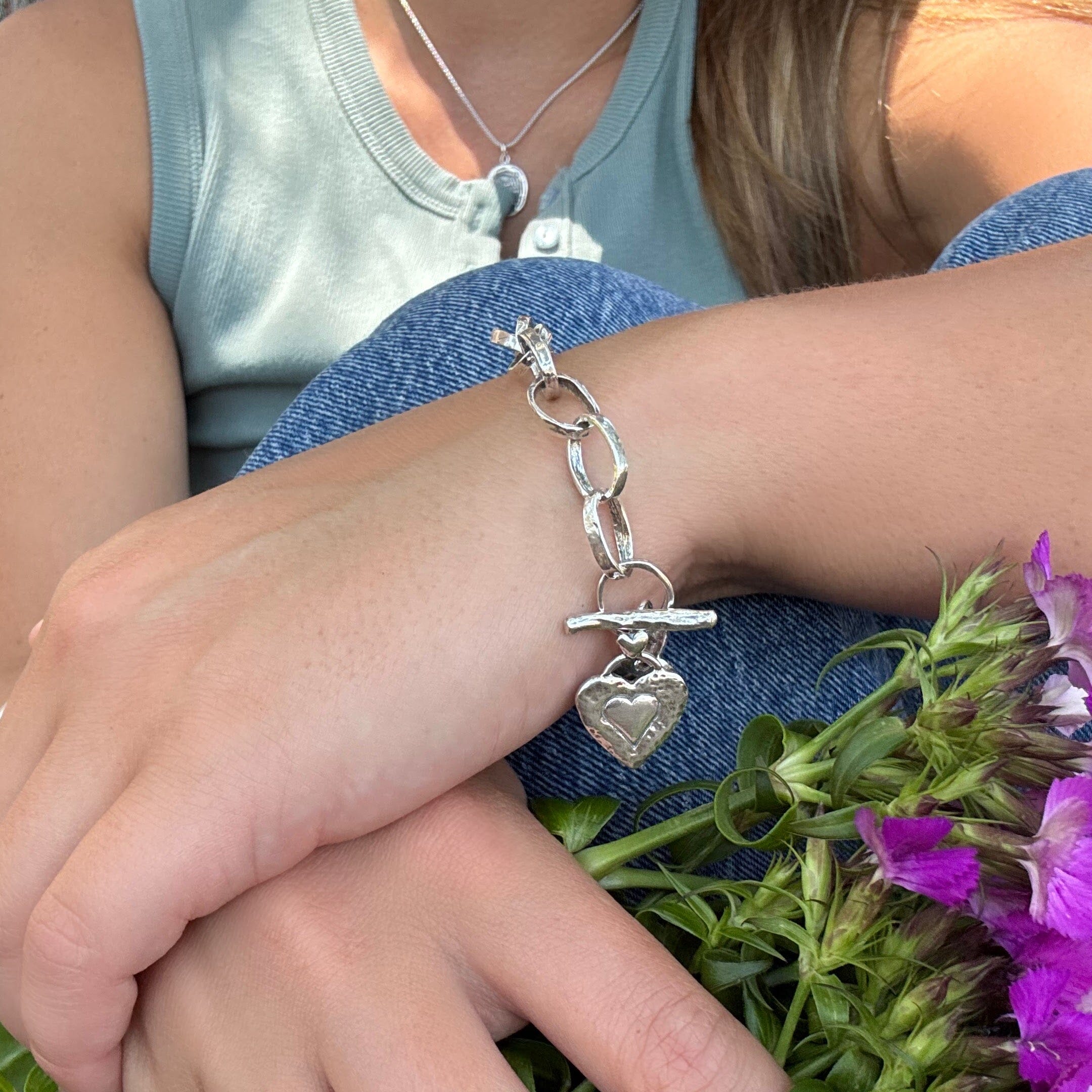organic silver link bracelet featuring a hammered heart dangle on the toggle clasp