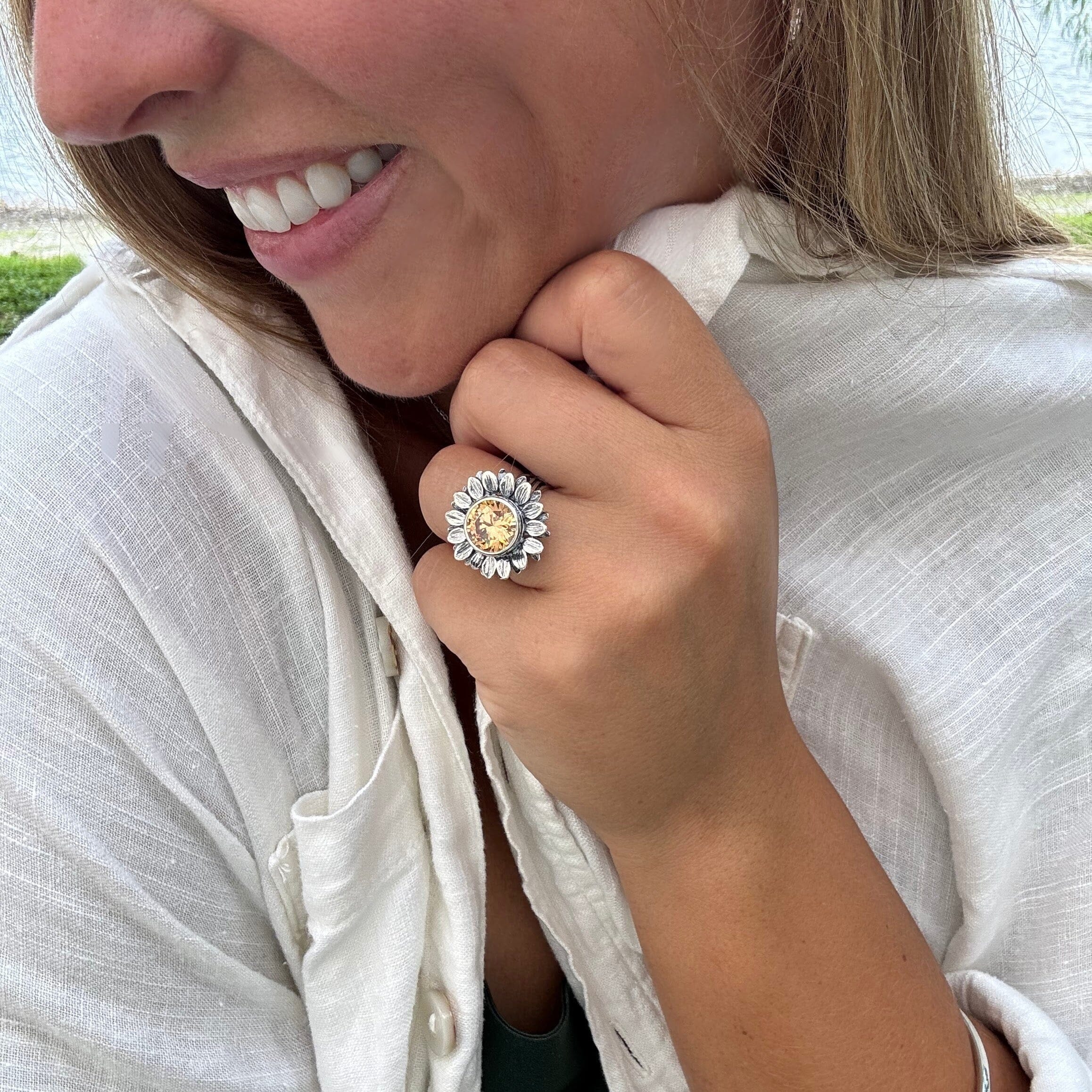 silver designer sunflower ring with an orange-colored center stone