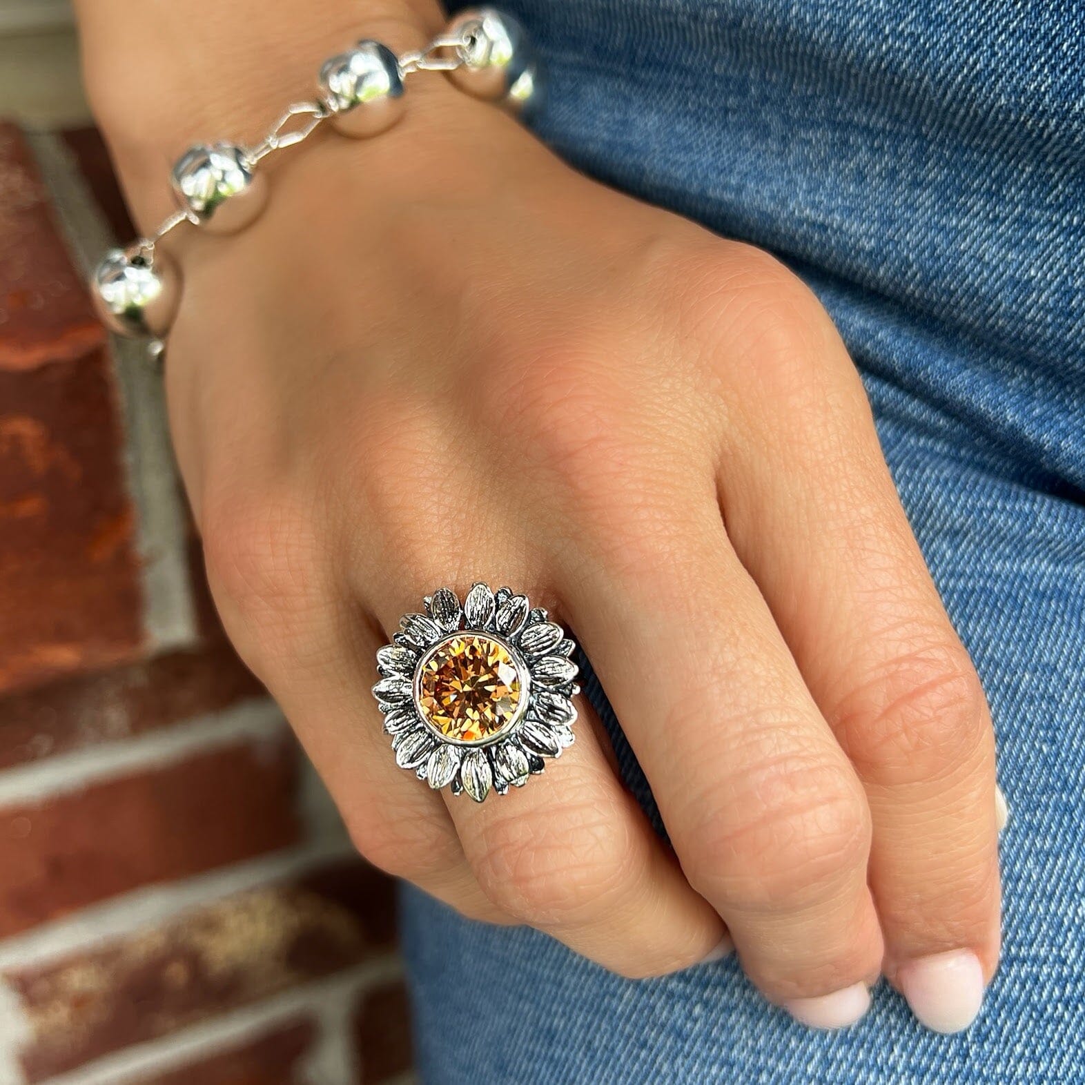 chunky silver sunflower design ring with a champagne cz center