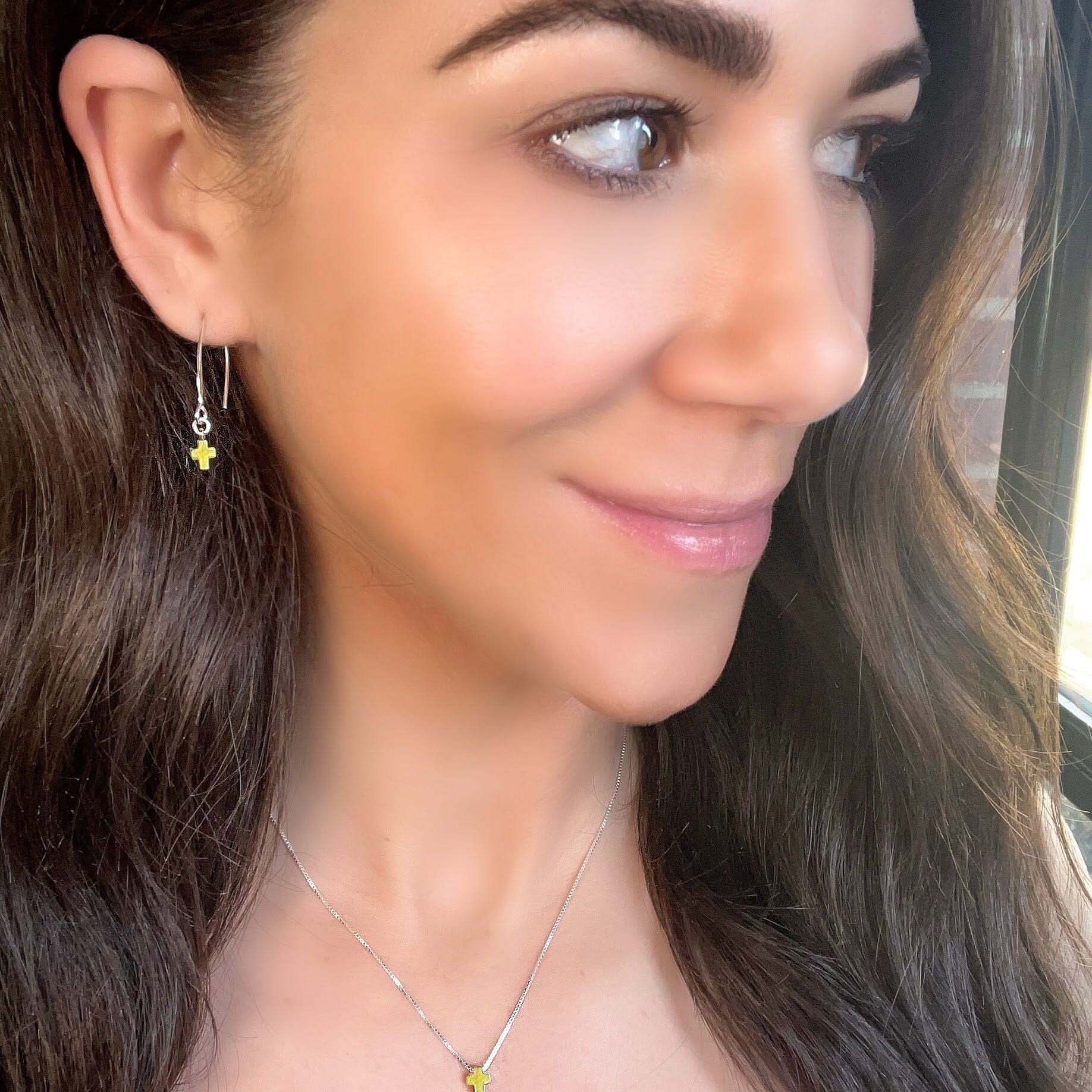 sterling silver earrings with a gold cross dangle