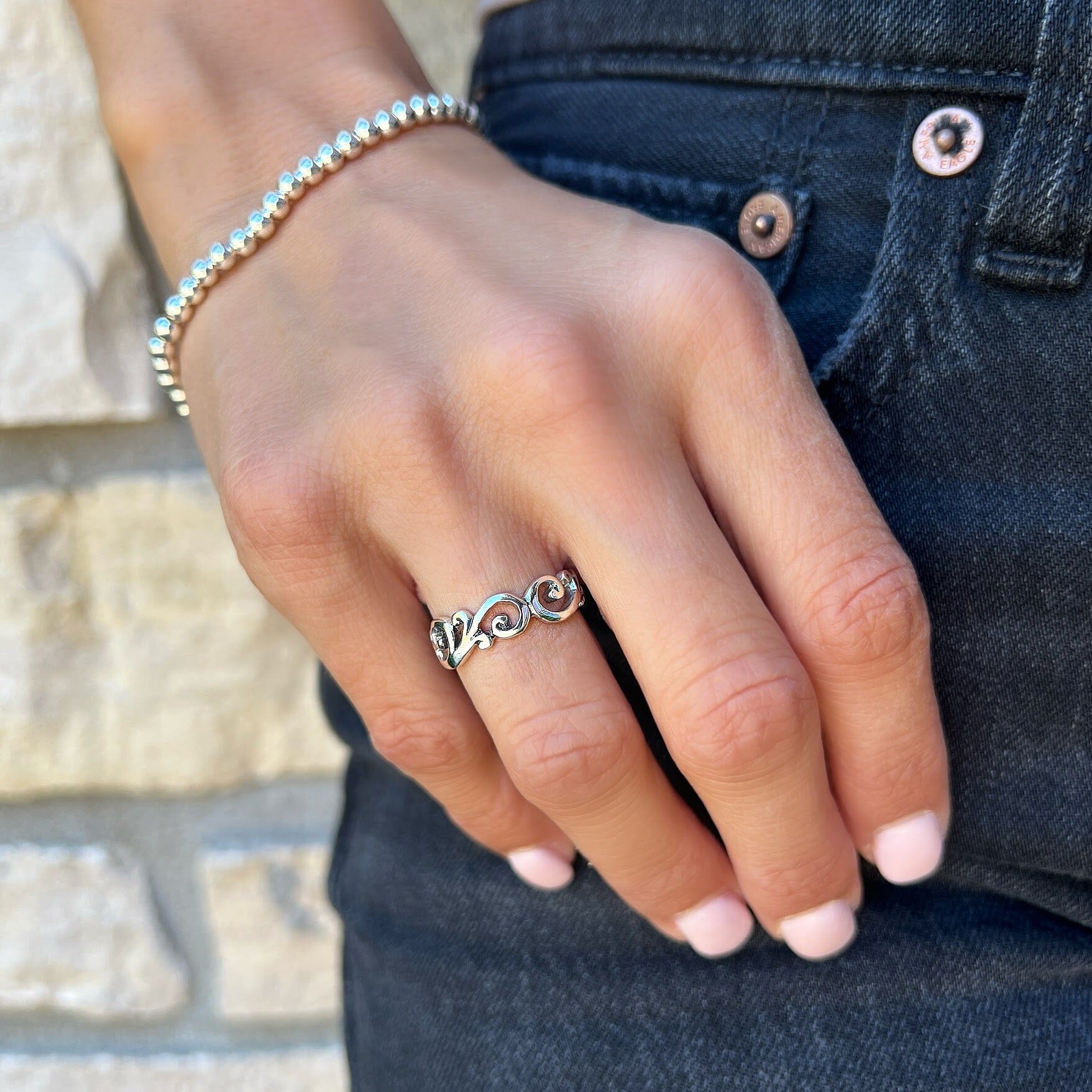 silver cut out ring design paired with the beaded stack bracelet