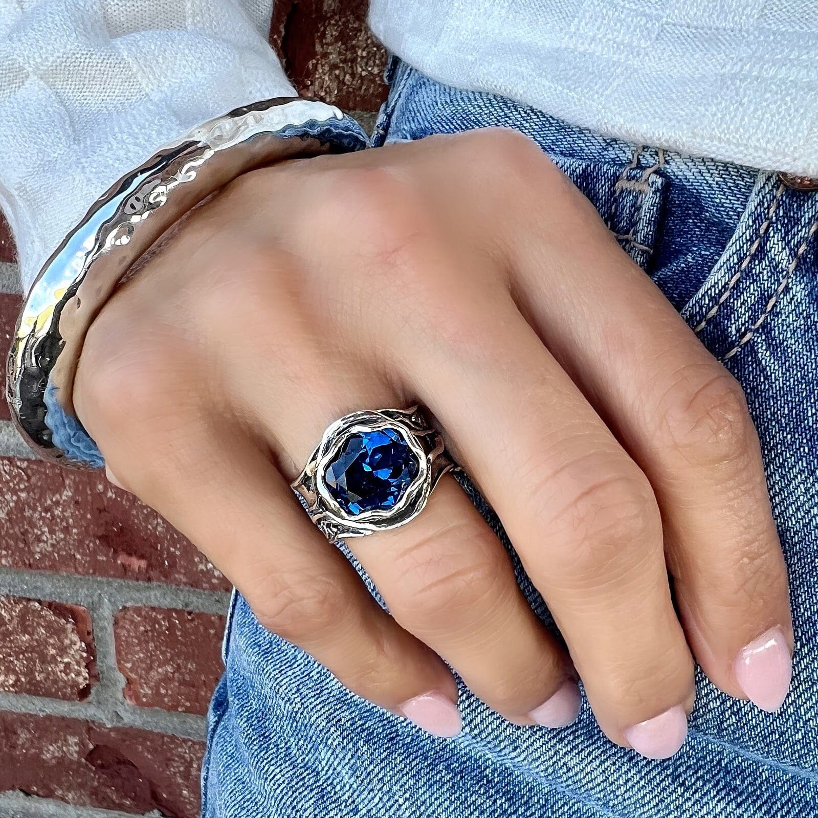 deep blue ring paired with a chunky hammered bangle