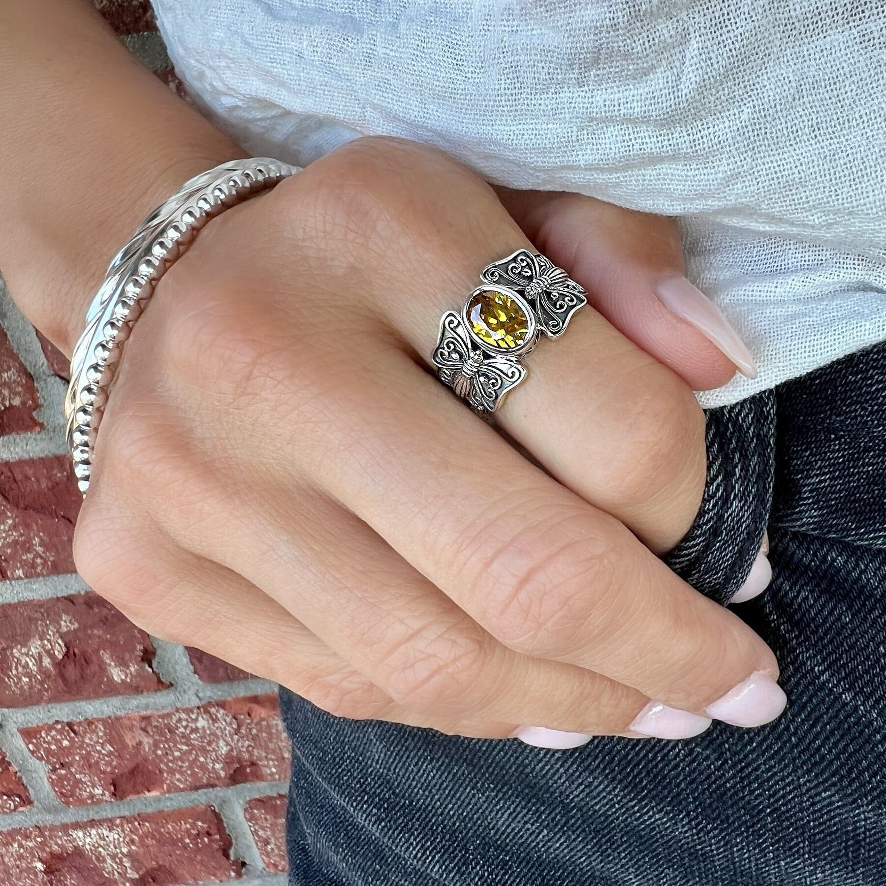 unique butterfly ring with an oxidized finish and oval citrine