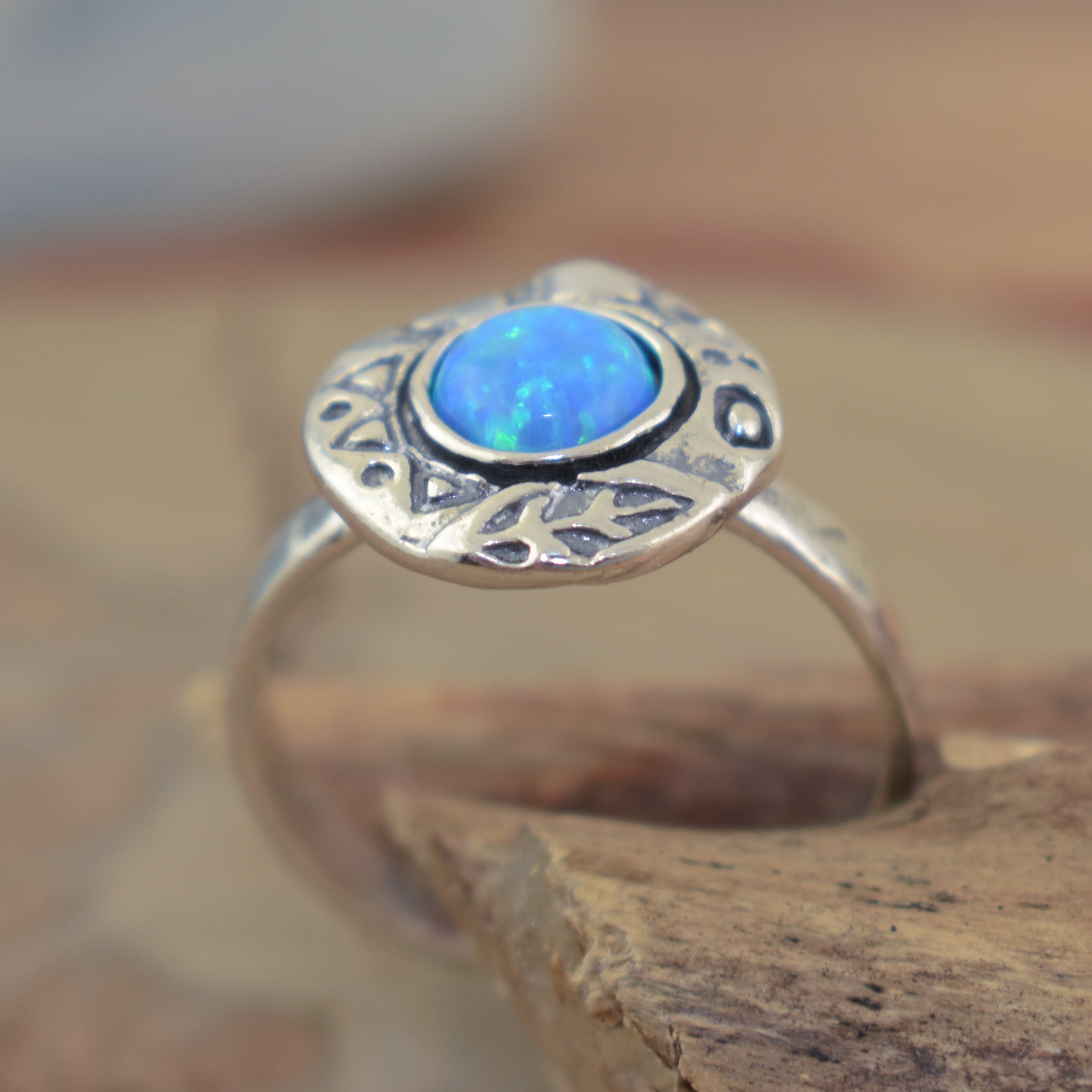 Whimsical sterling silver ring featuring blue opal and antiqued sterling silver band with heart, star, and leaf stamped accents