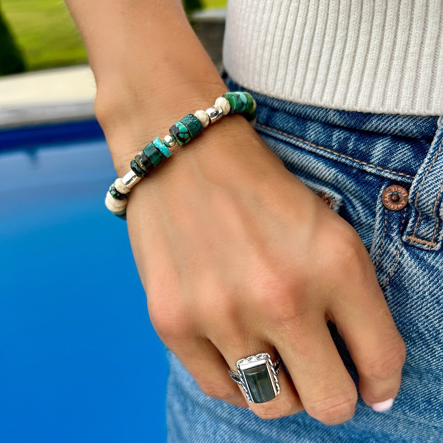 Turquoise and Pyrite stones with sterling silver beads one a stretch bracelet