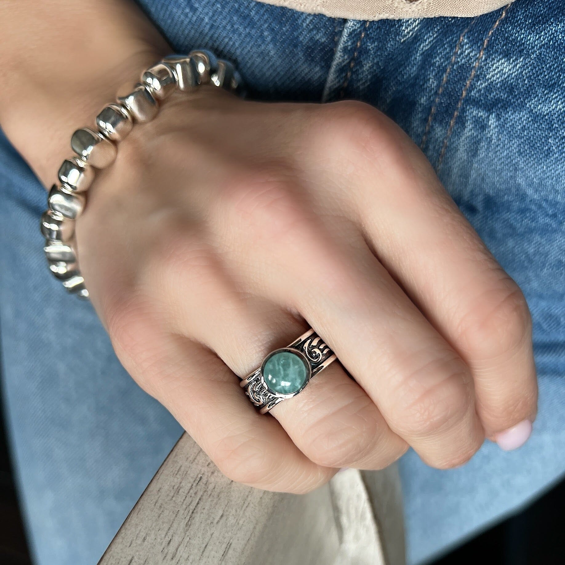 sterling silver ring featuring a detailed band and a Amazonite stone