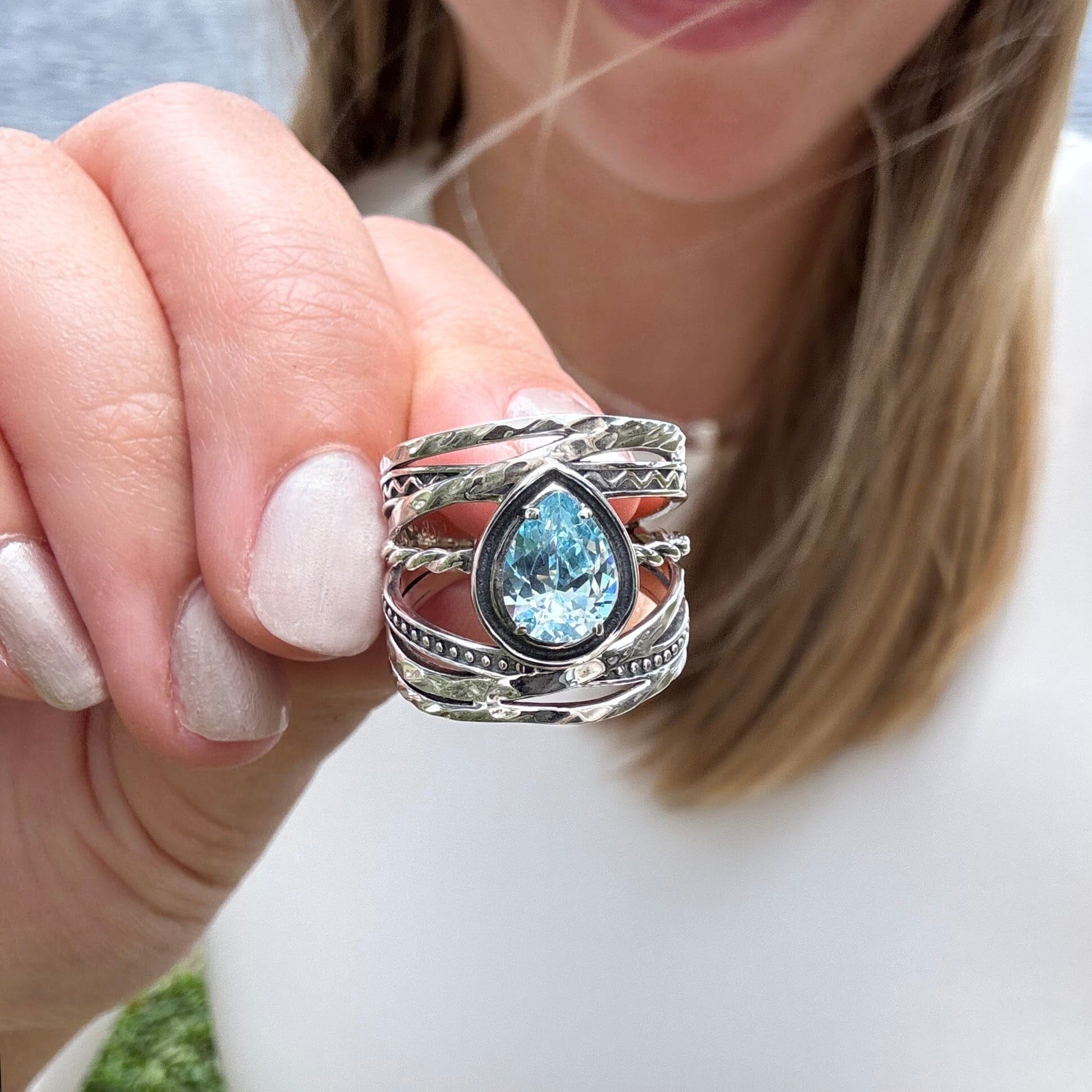 beach style sterling silver ring with organic style bands and a sky blue cz stone