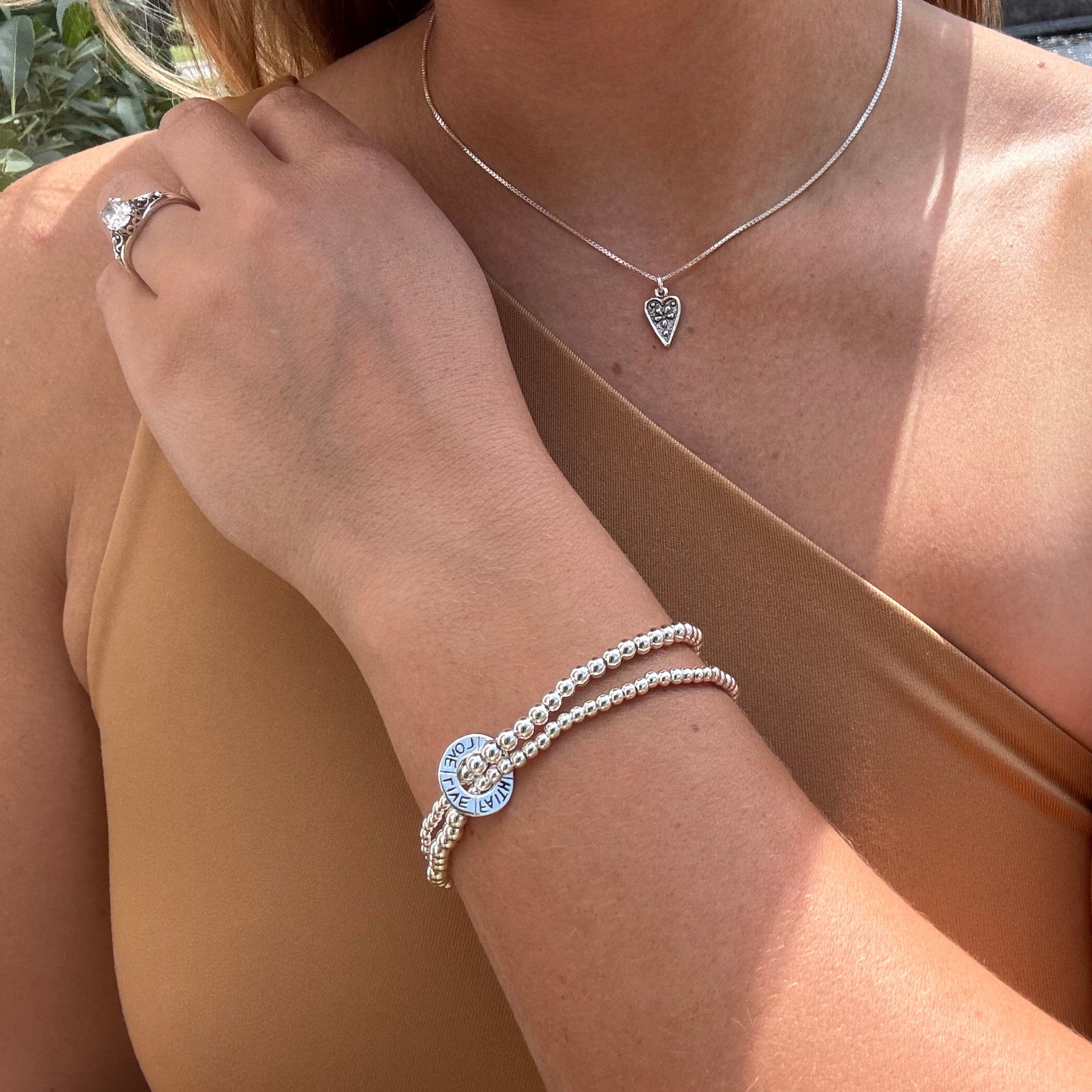 Handcrafted sterling silver stretch bracelet with words live, faith, hope, and love