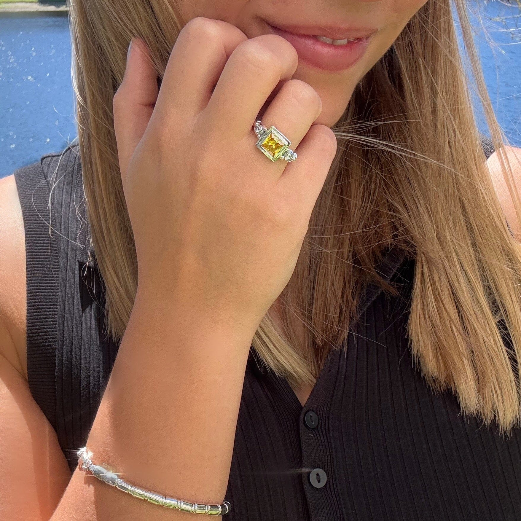 sterling silver ring with a square cut  Saffron stone and Clear CZ stones on the side paired with the Tubertini bracelet