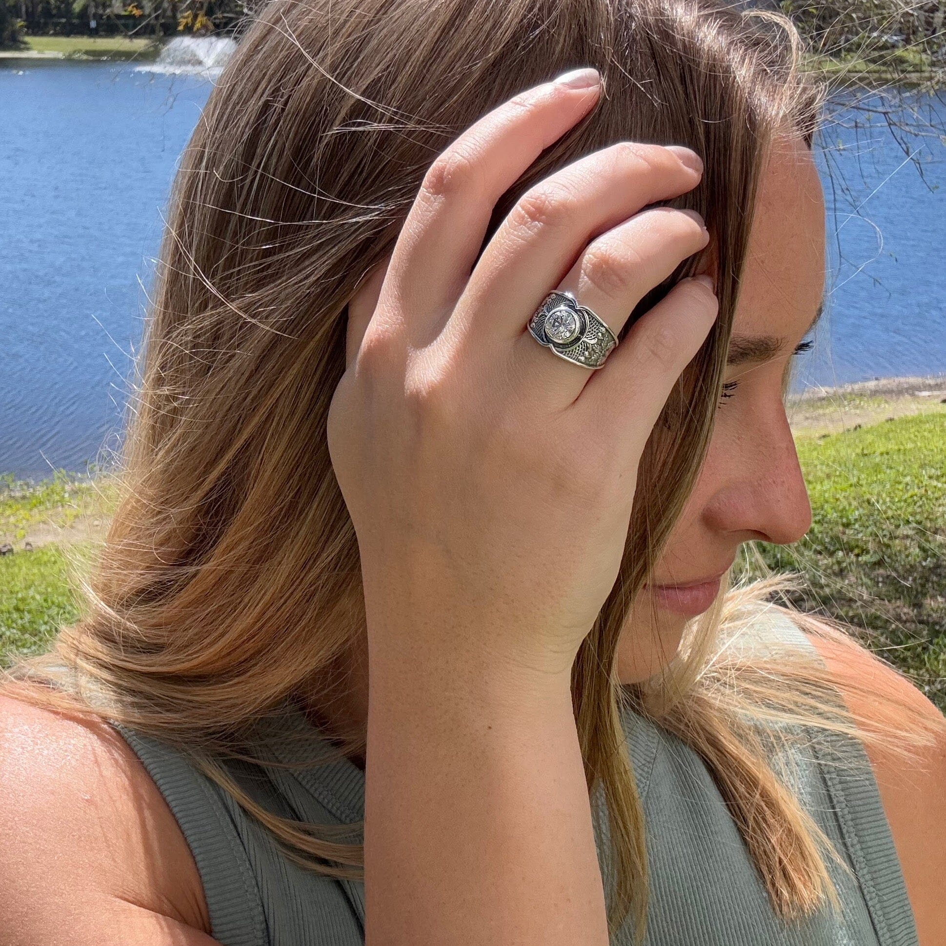 oxidized silver ring featuring high polished tropical leaf and wicker designs with a center CZ