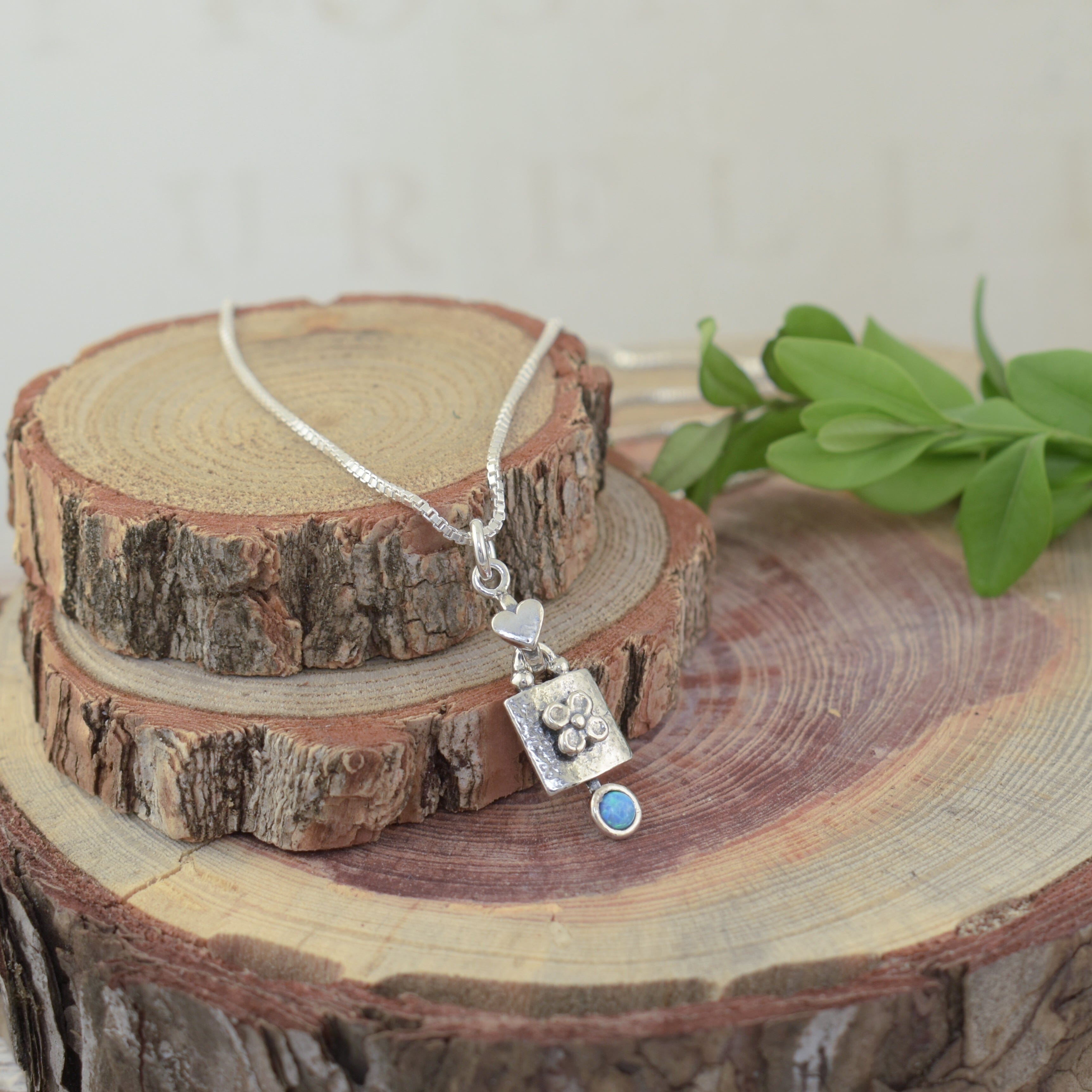 .925 srerlign silver flower and heart neckalce featuring blue green recontructed opal