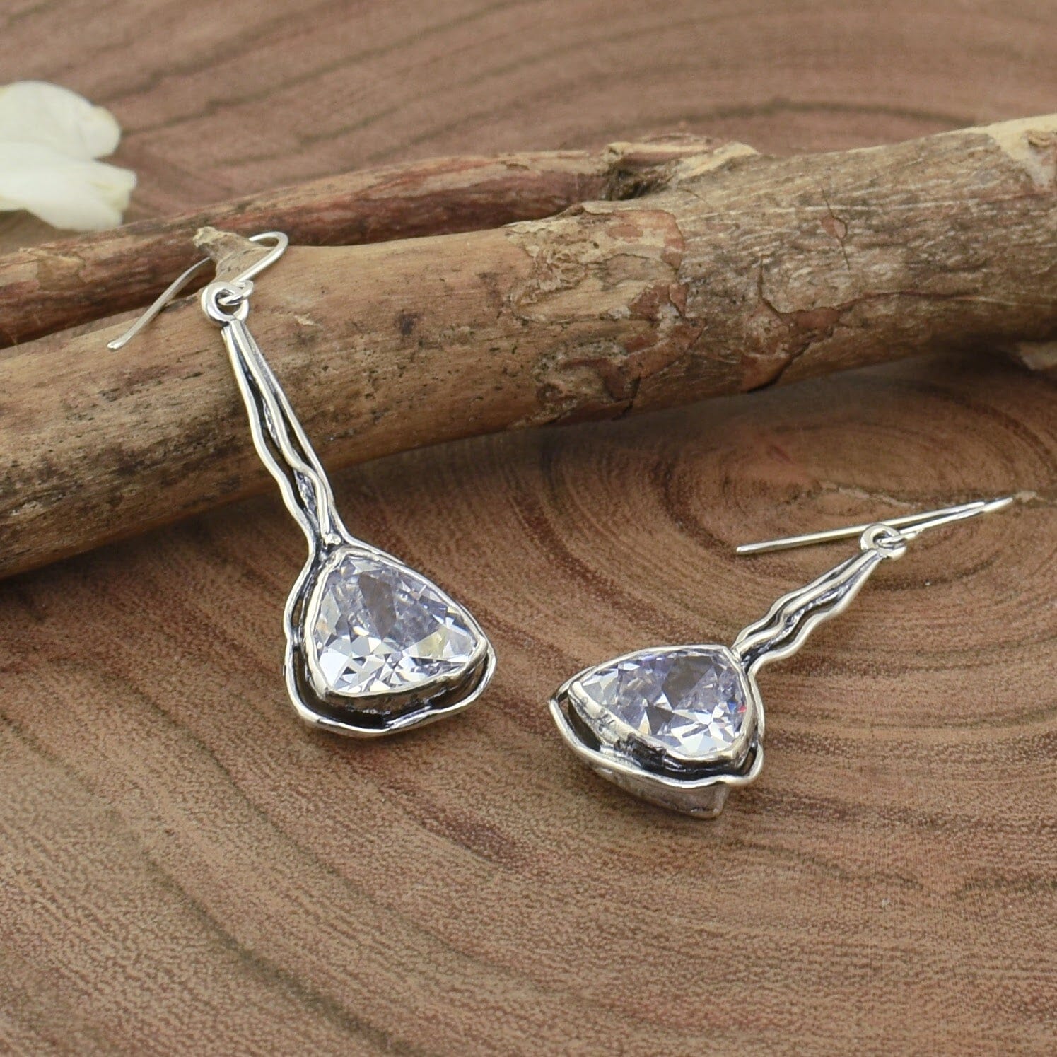 long dangling earrings featuring a triangular cz