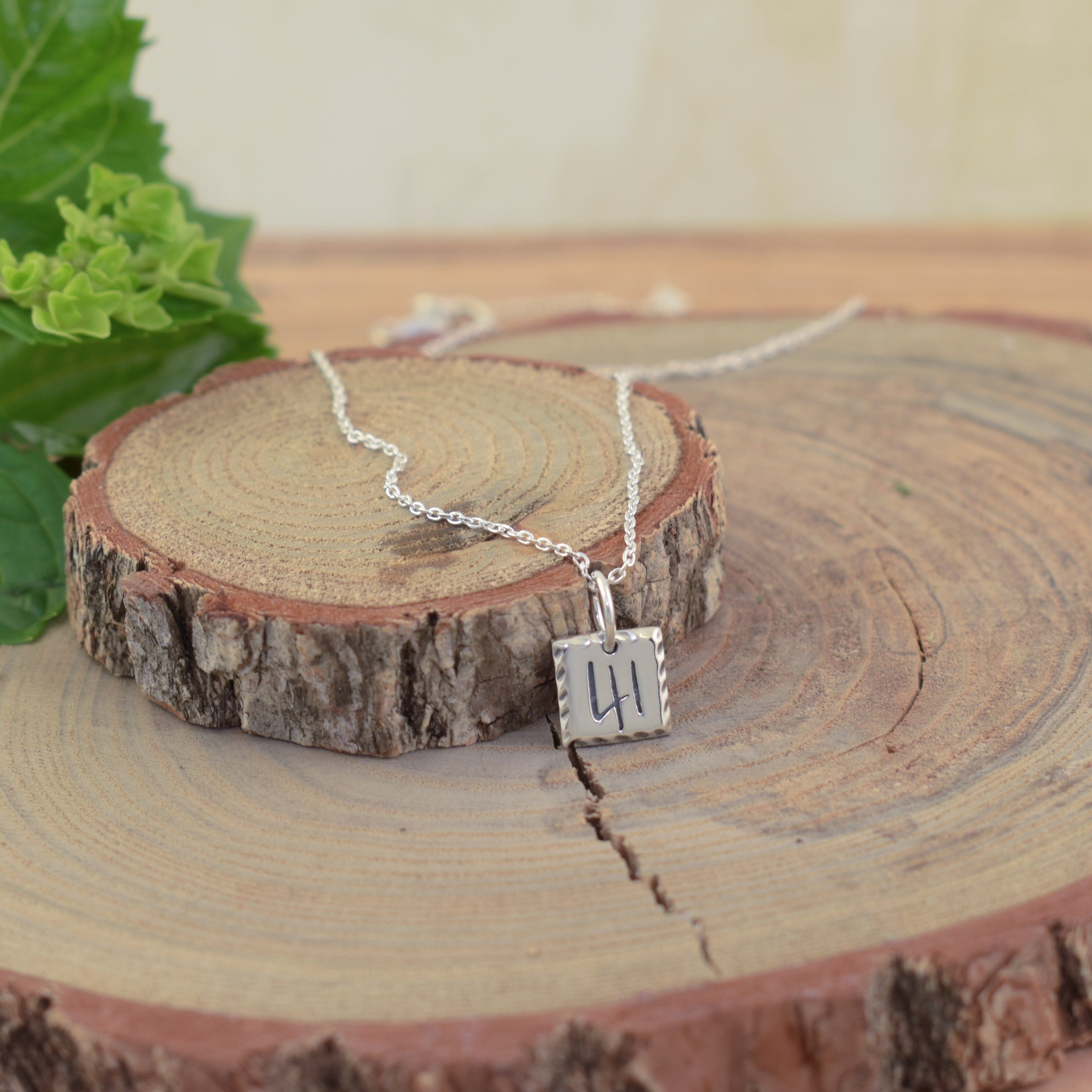 Christian inspired necklace featuring a silver square pendant engraved with the number 41