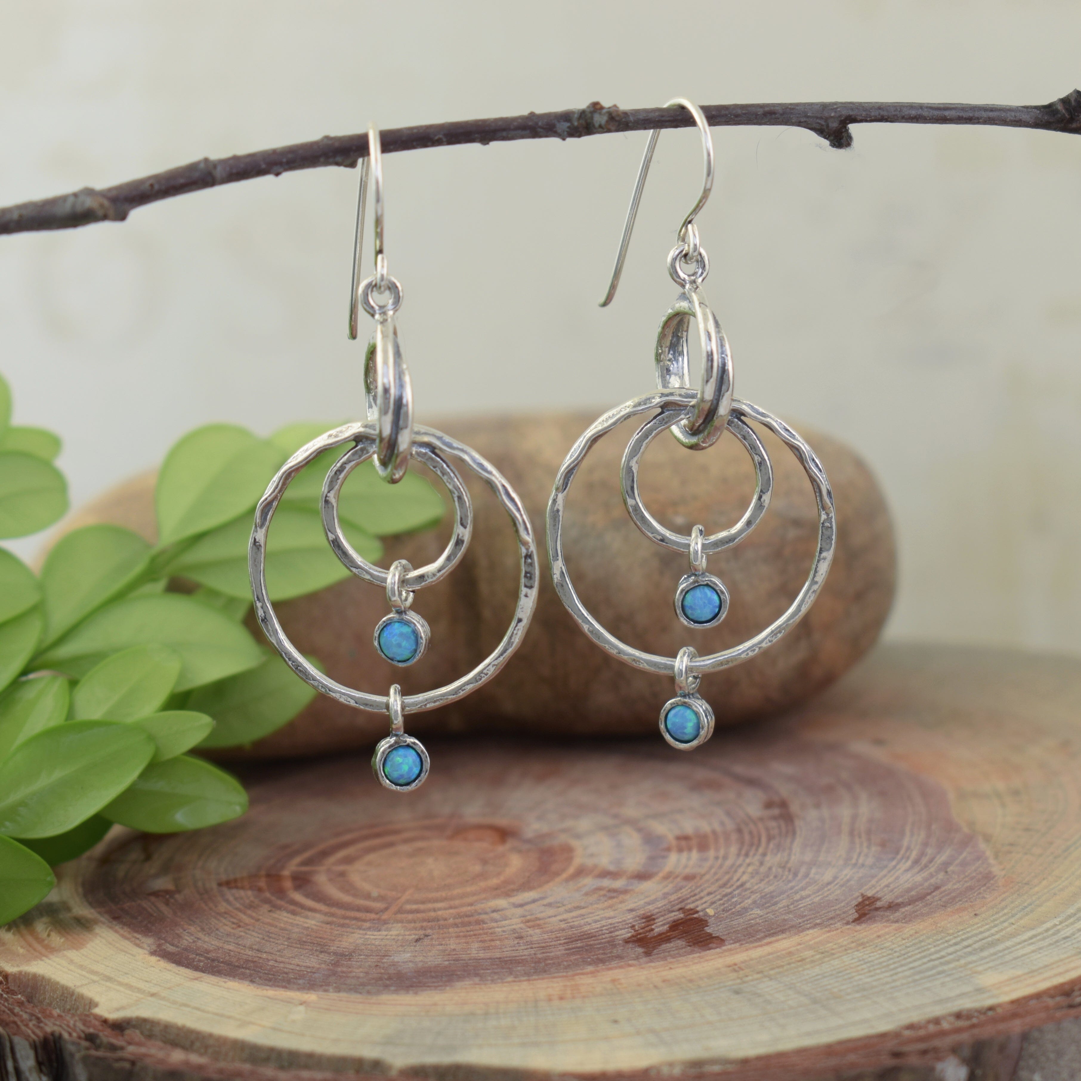 .925 sterling silver dangle earrings featuring blue green reconstructed opal