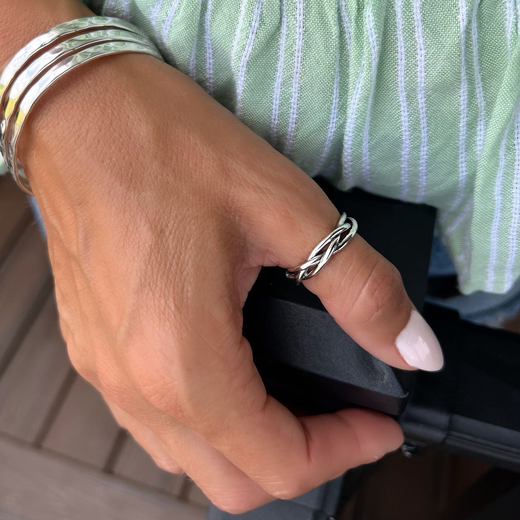 twisting thumb ring paired with a hammered cuff bracelet