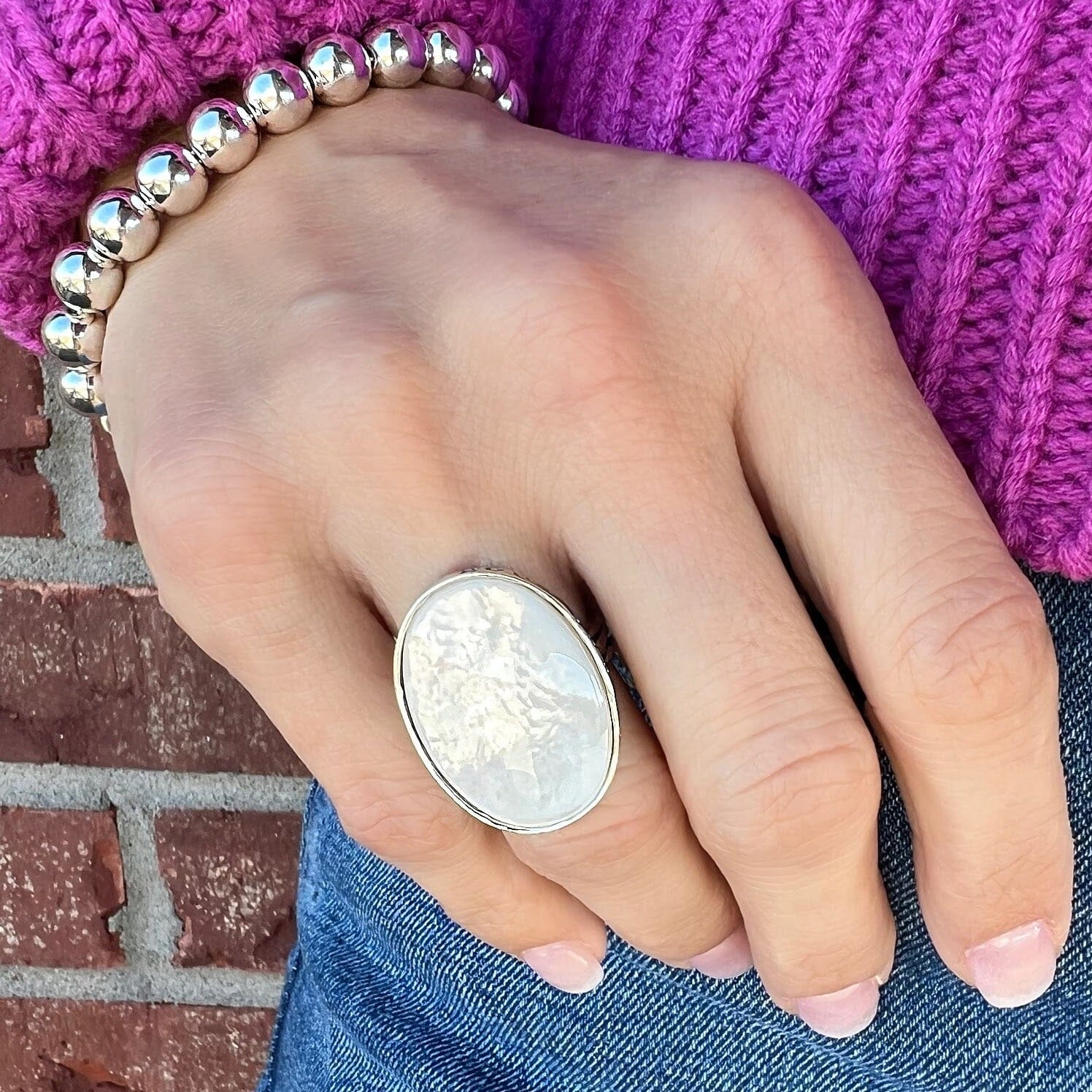 large oval-shaped ring featuring mother-of-pearl