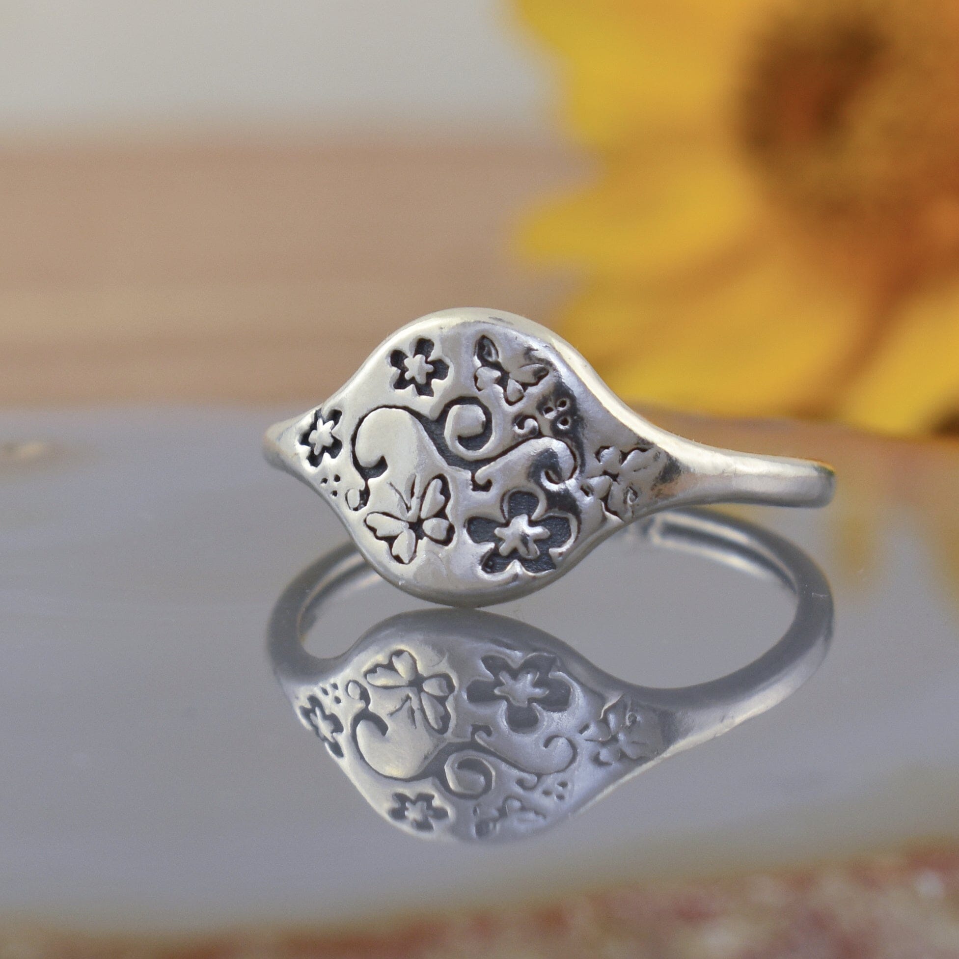 sterling silver signet style ring engraved with flowers and butterflies