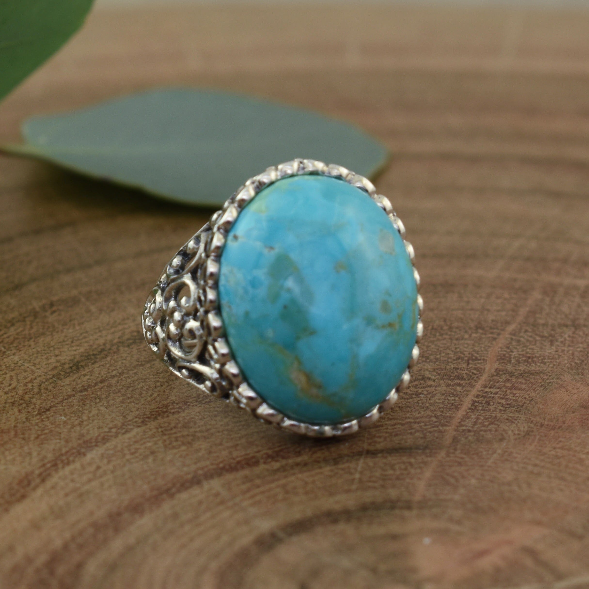 chunky ring with oval beaded frame featuring a bright turquoise stone