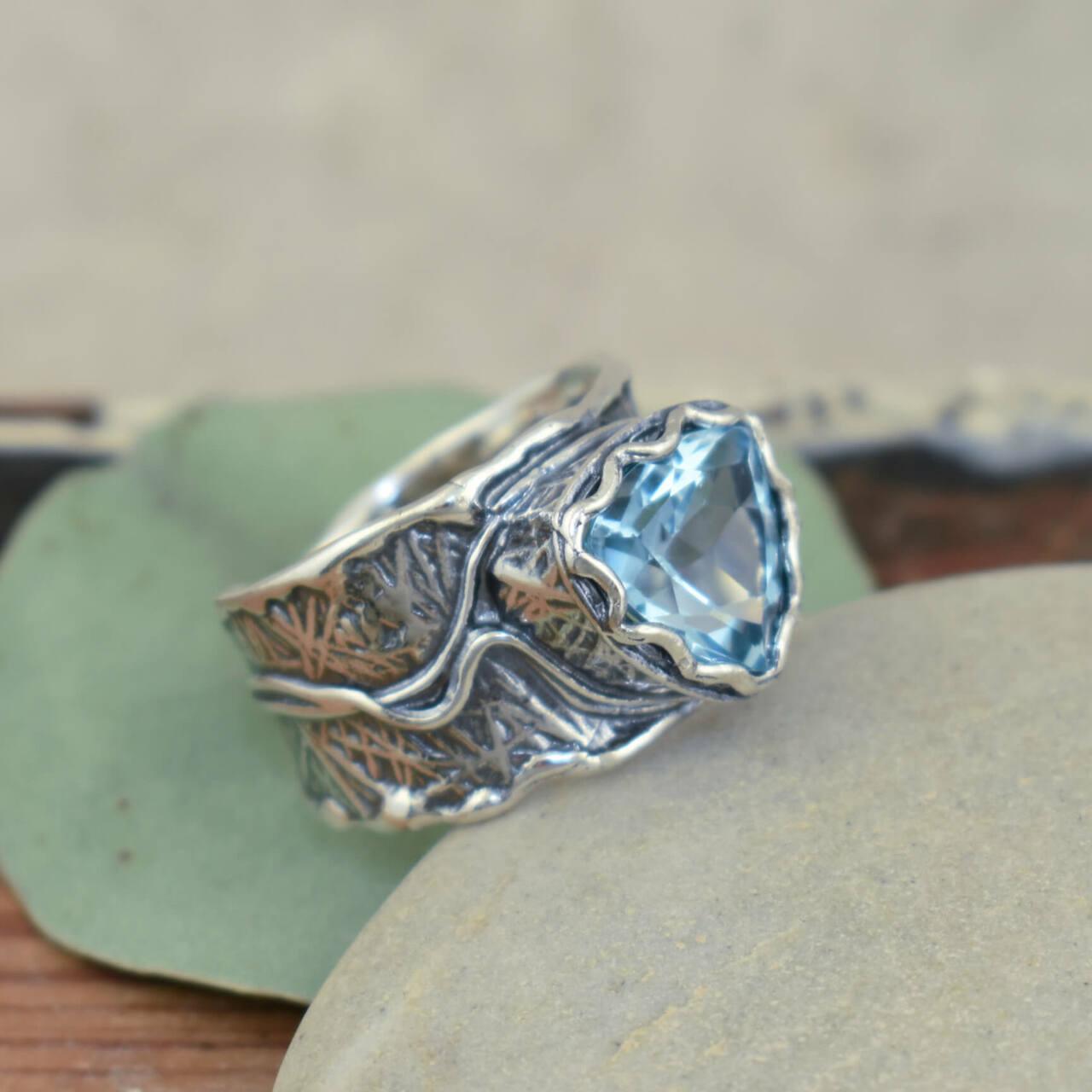 Handcrafted sterling silver ring featuring blue topaz