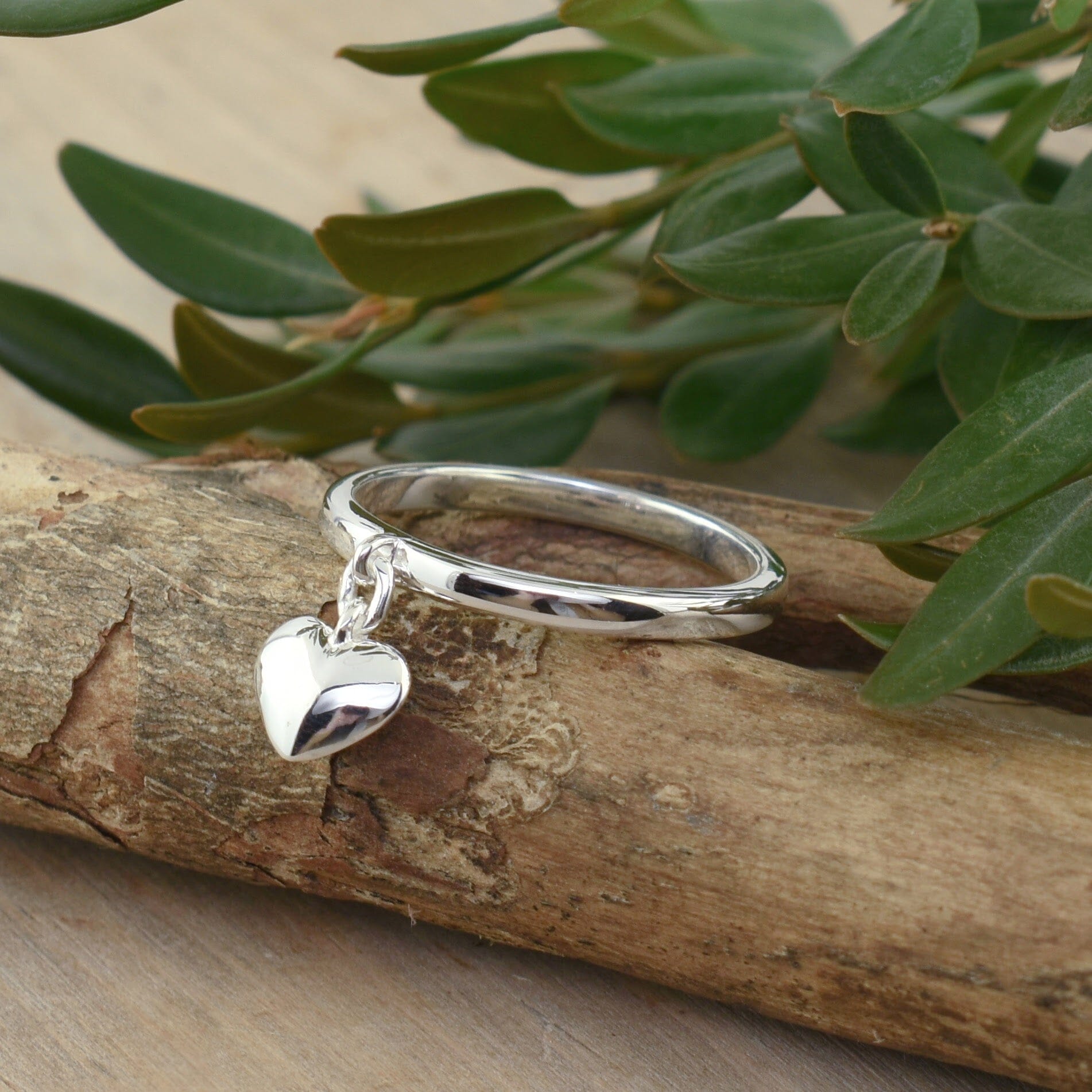 dainty .925 sterling silver ring with a dangling heart