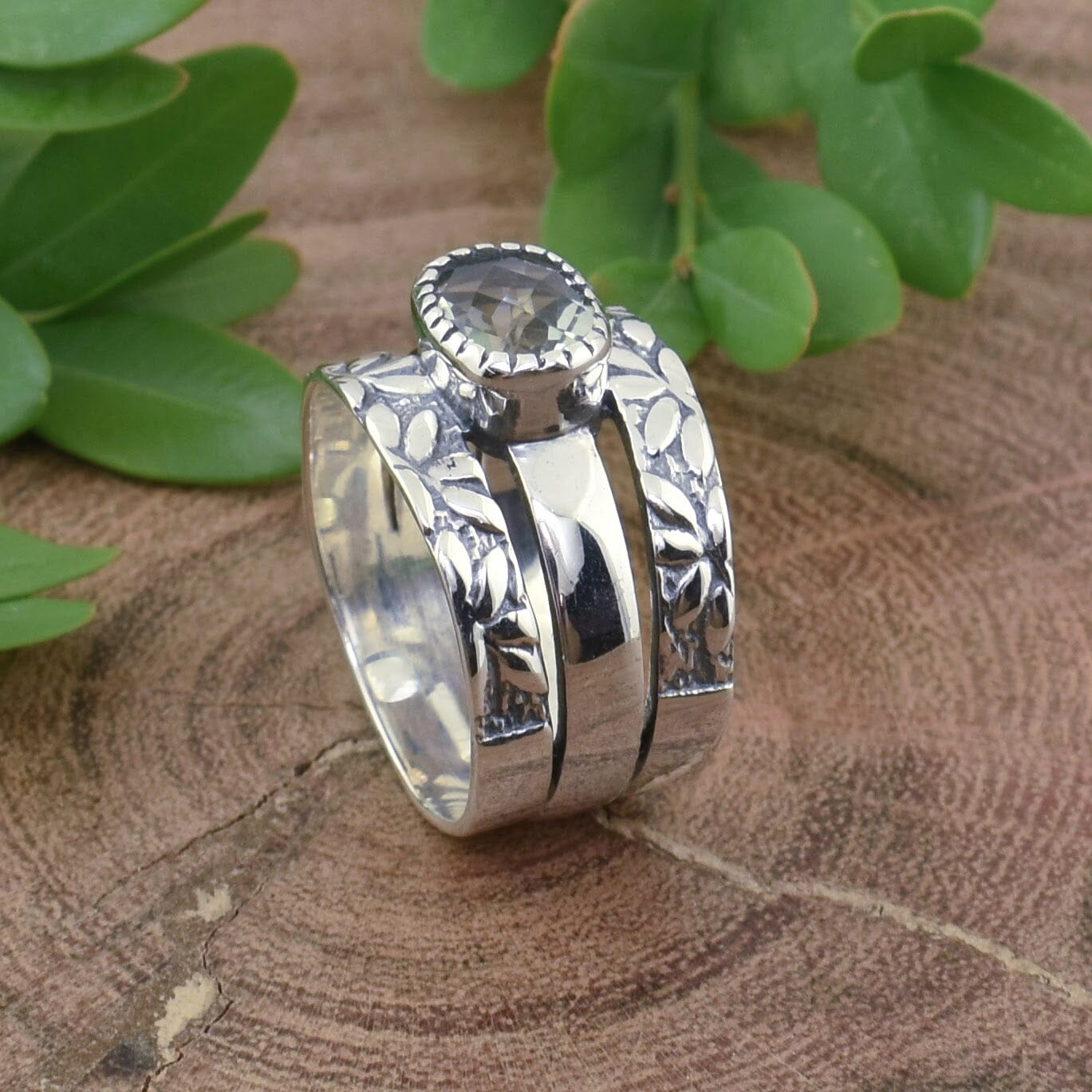 light green amethyst ring with botanical vines on the band