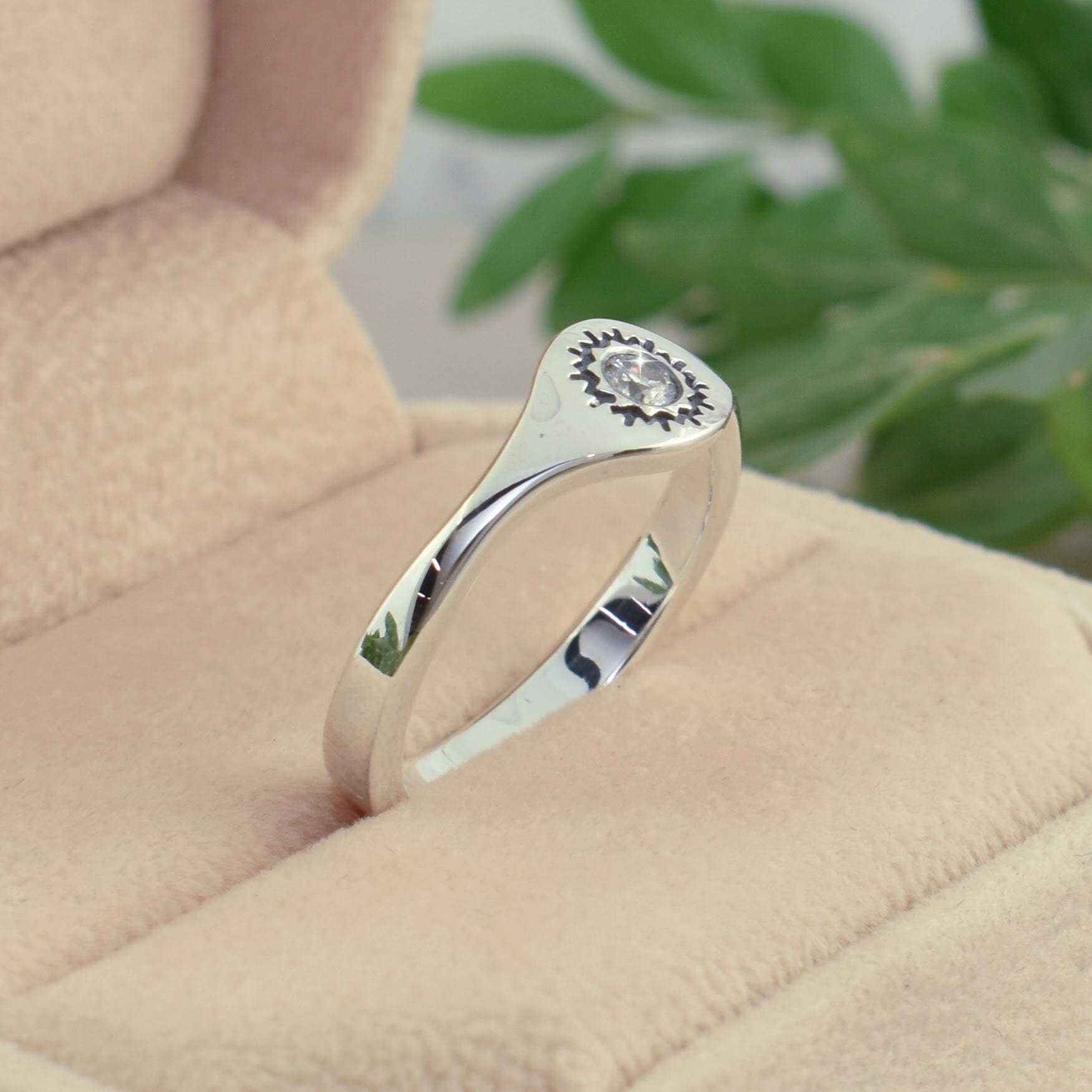 sterling silver ring with a pattern around the diamond stone