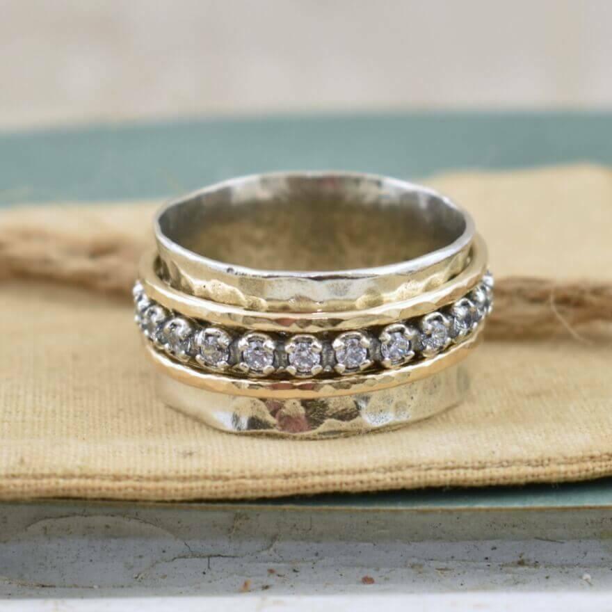 Hammered sterling silver ring with gold and cz spinning bands