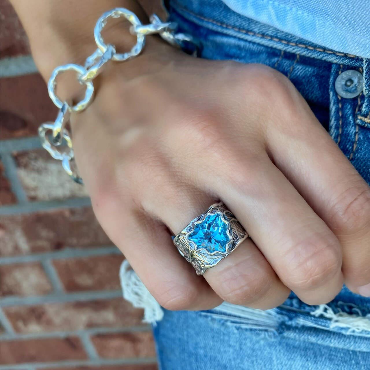 Designer ring in sterling silver with center blue topaz stone