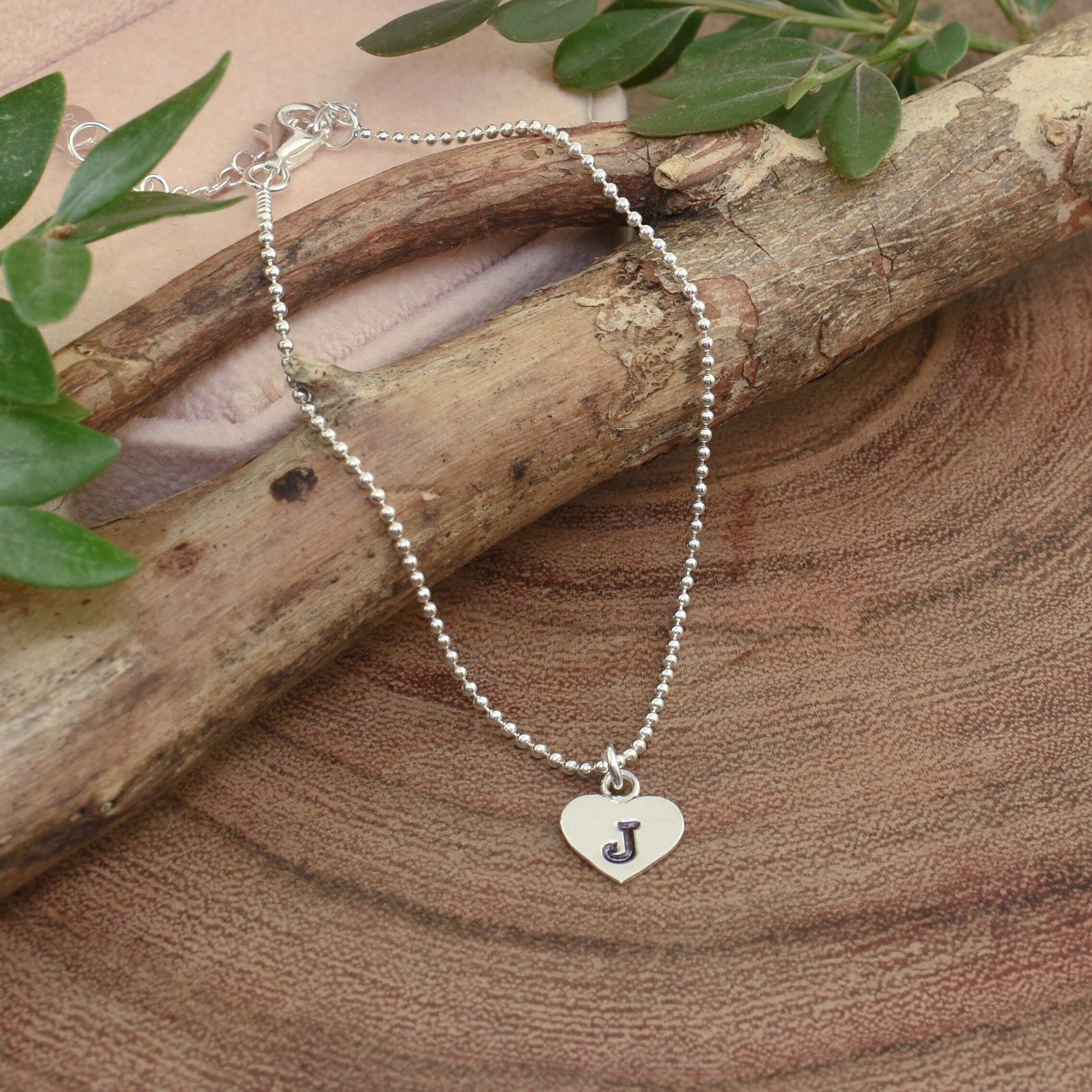 minimalist heart bracelet with a stamped initial