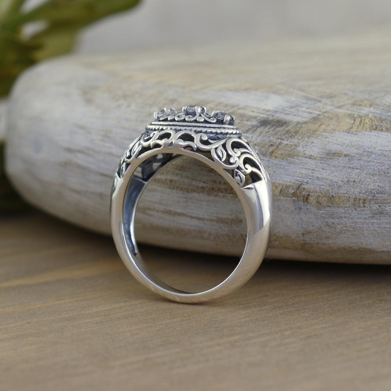 Handcrafted sterling silver vintage ring with filigree swirl background