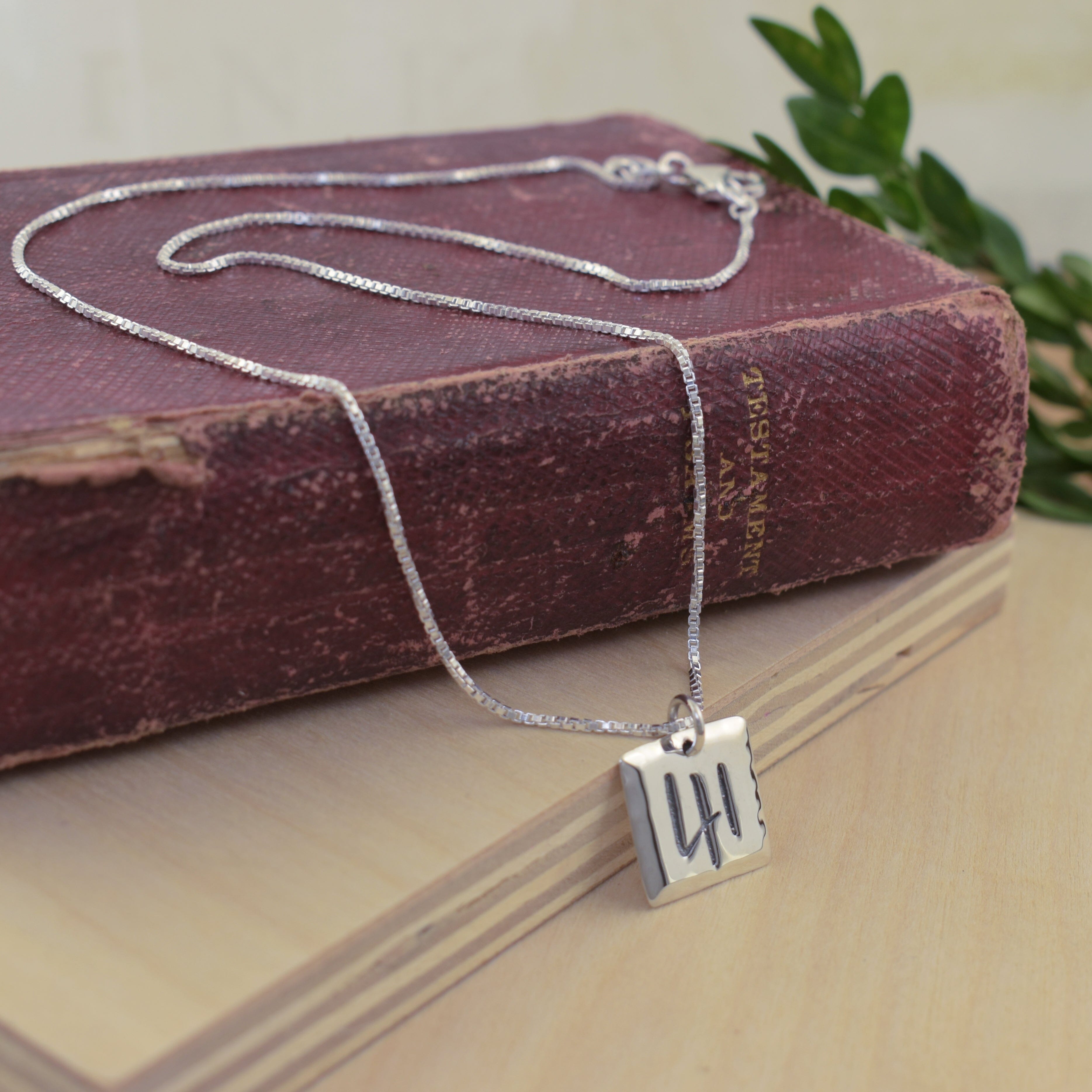 Christian inspired necklace featuring a silver square pendant engraved with the number 41