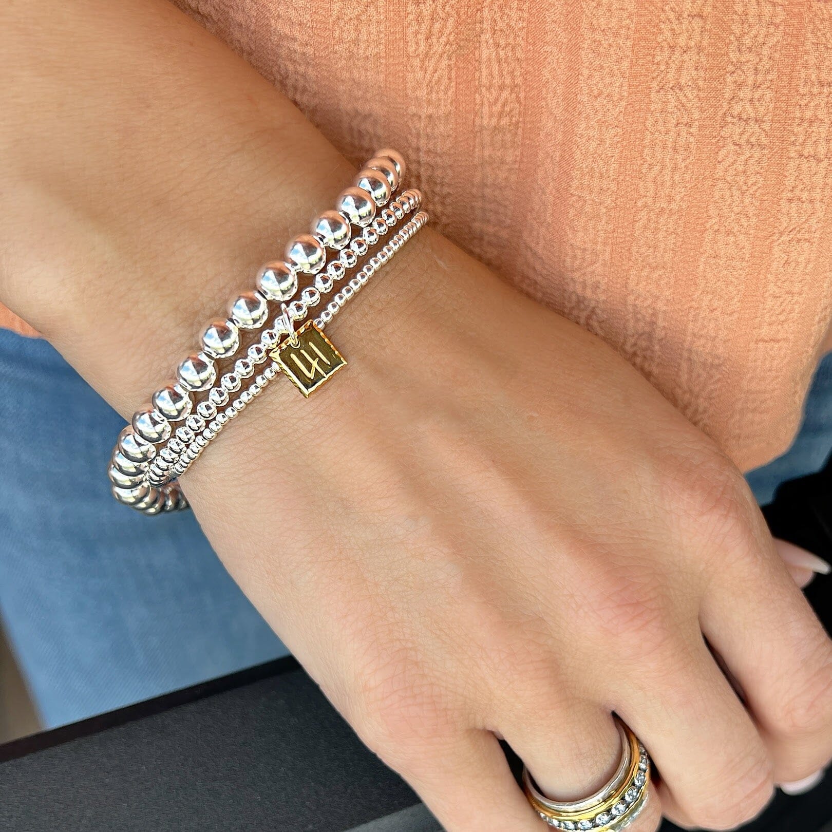gold 41 cuff stacked with Beaded Stack Bracelets in the 2mm and 6mm sizes
