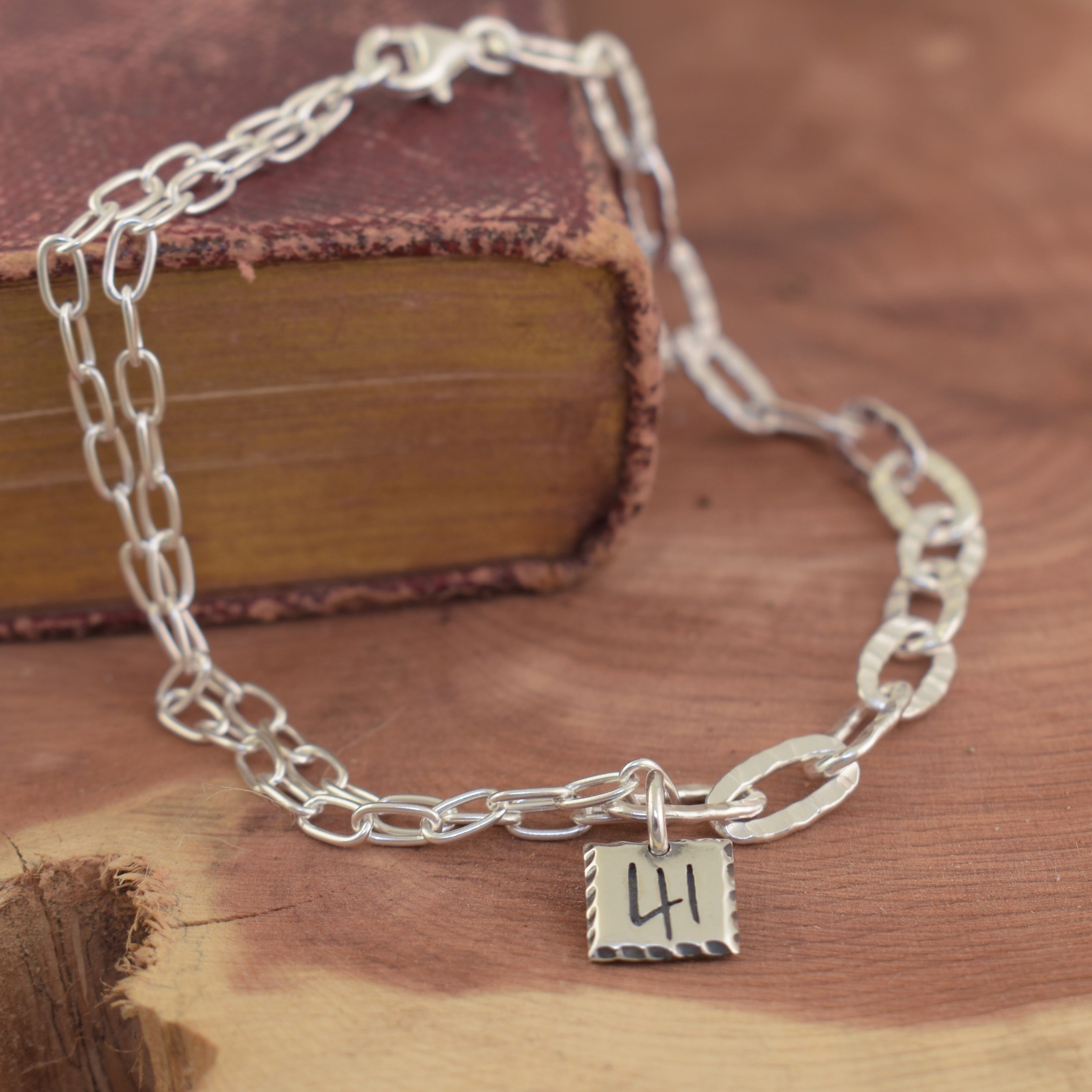 sterling silver paper clip chain bracelet with a hand crafted 41 pendant on it