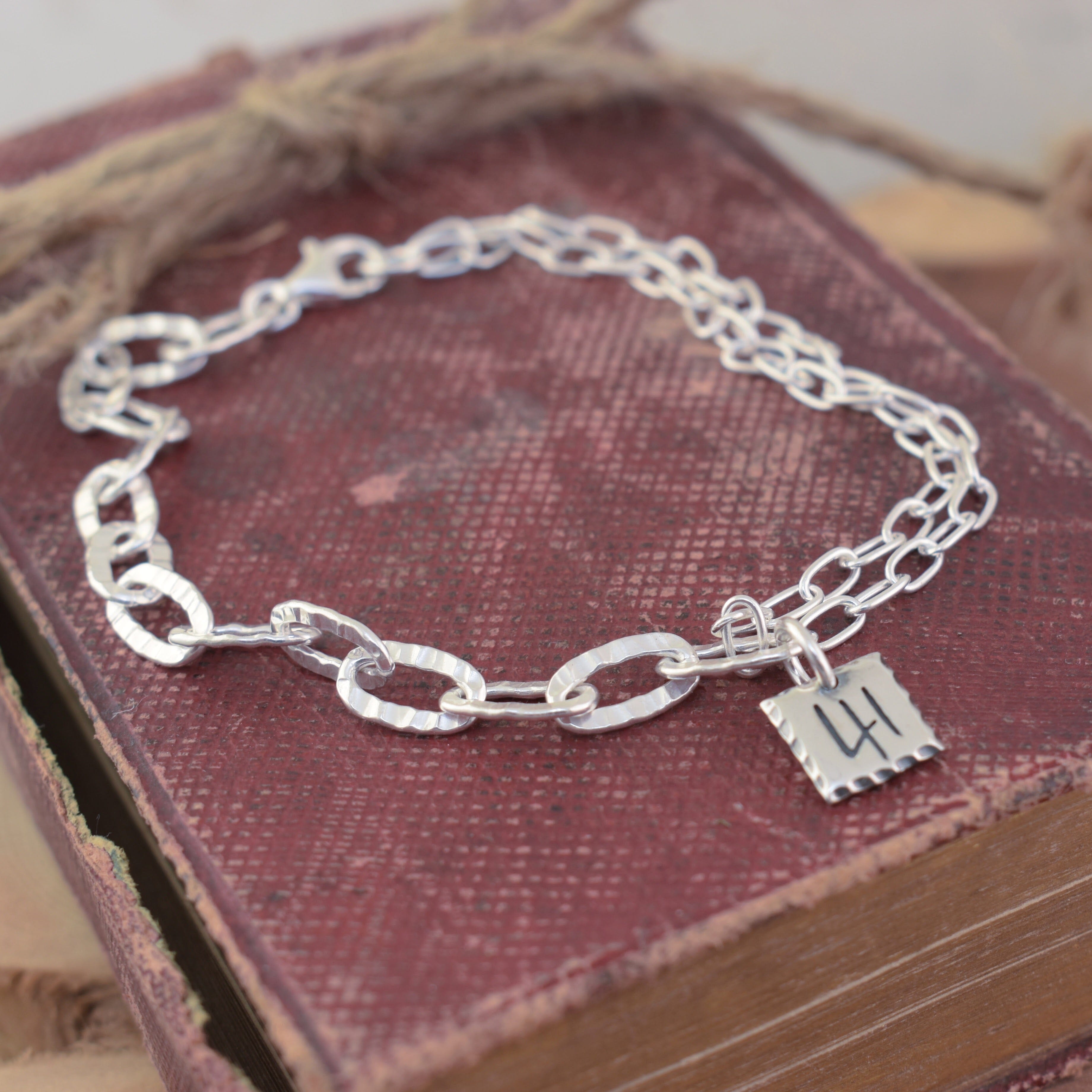 two different styles of paper clip chain links and in the center is a 41 pendant