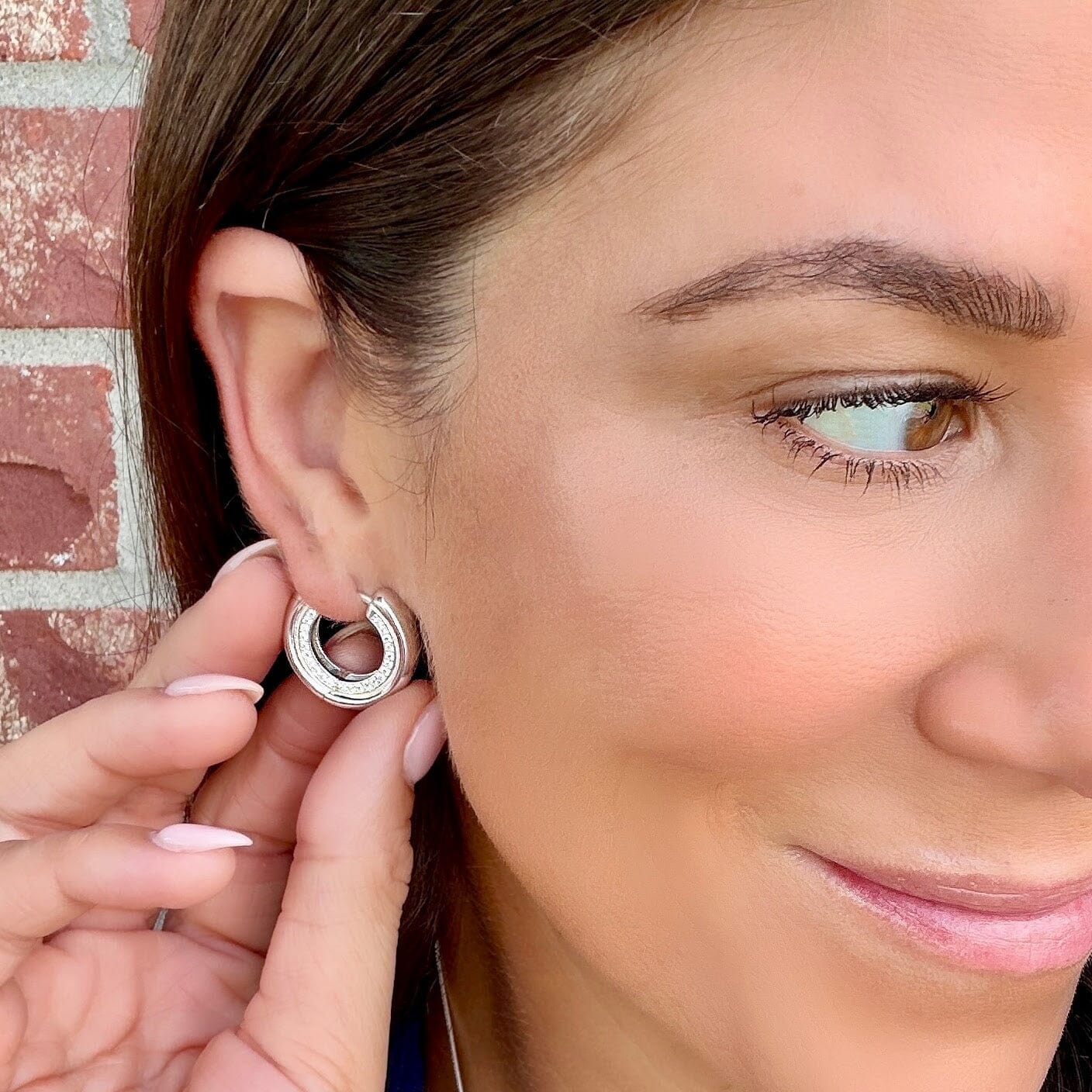silver plated hoops featuring paved czs on the side