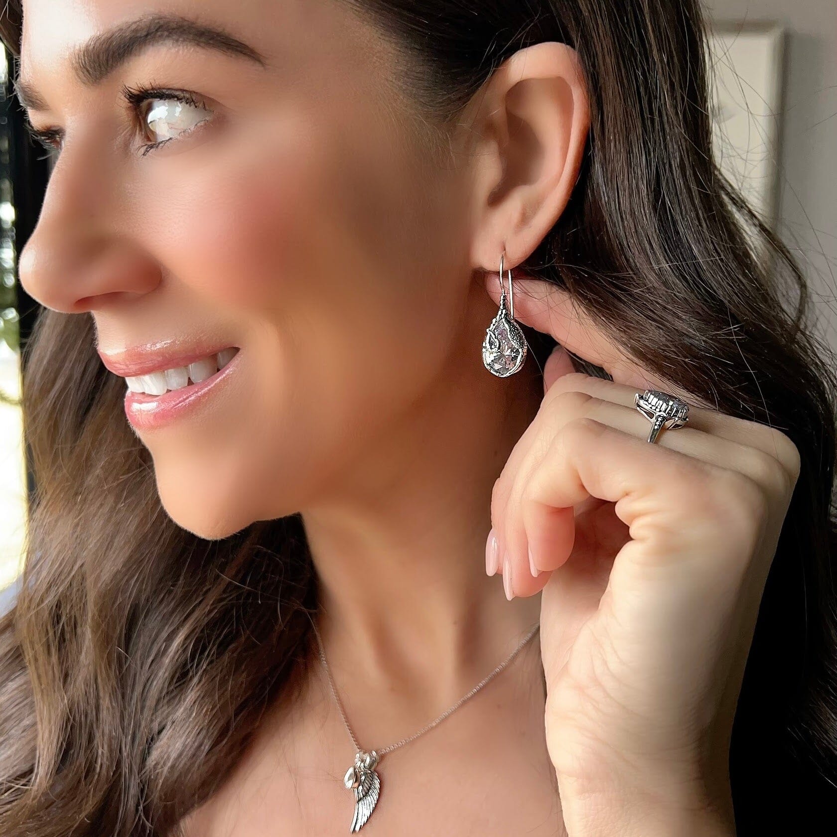 sterling silver unique drop shaped earrings with a CZ stone