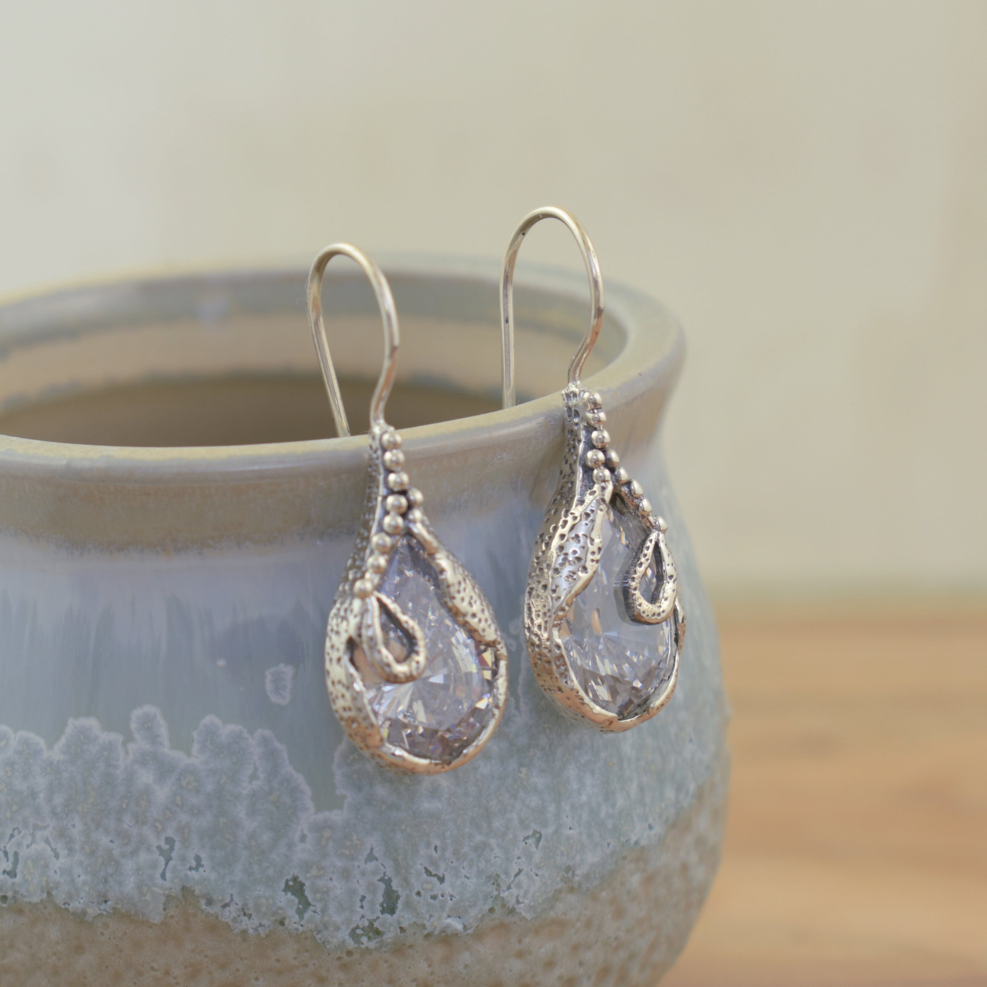 sterling silver wire hook earrings featuring pear shaped cubic zirconia