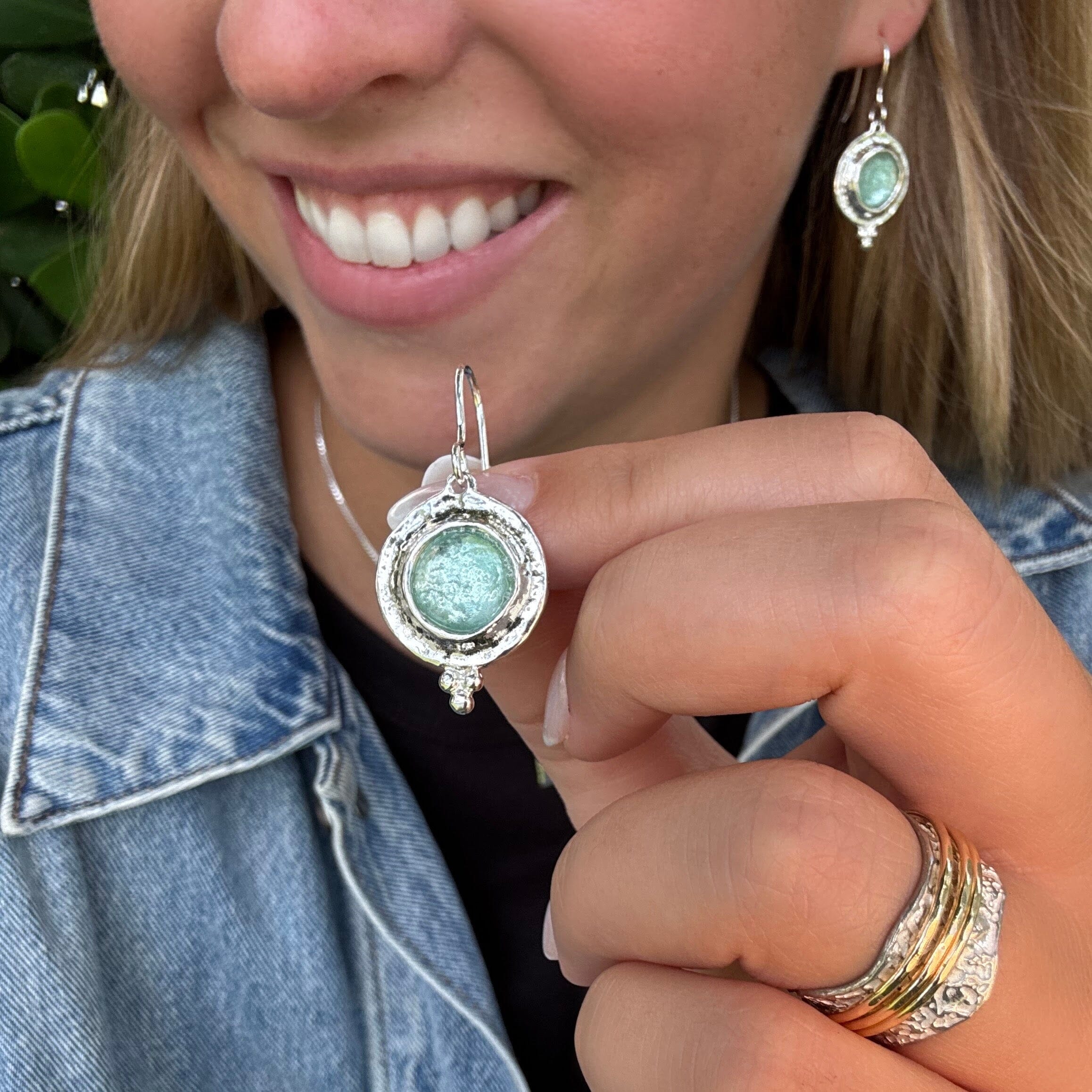 sterling silver dangling earrings featuring a round Roman Glass stone