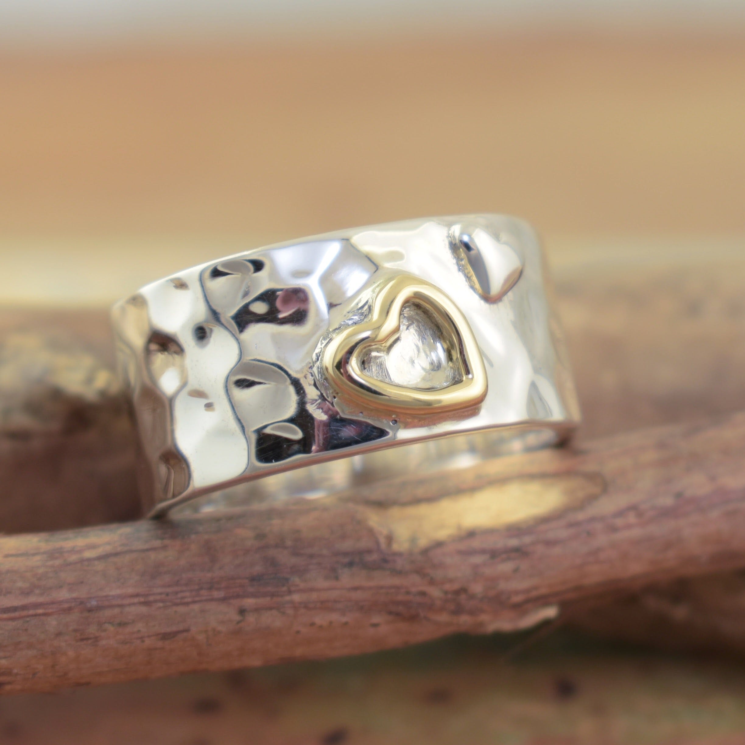 Sterling silver wide band ring with a hammered band and heart details