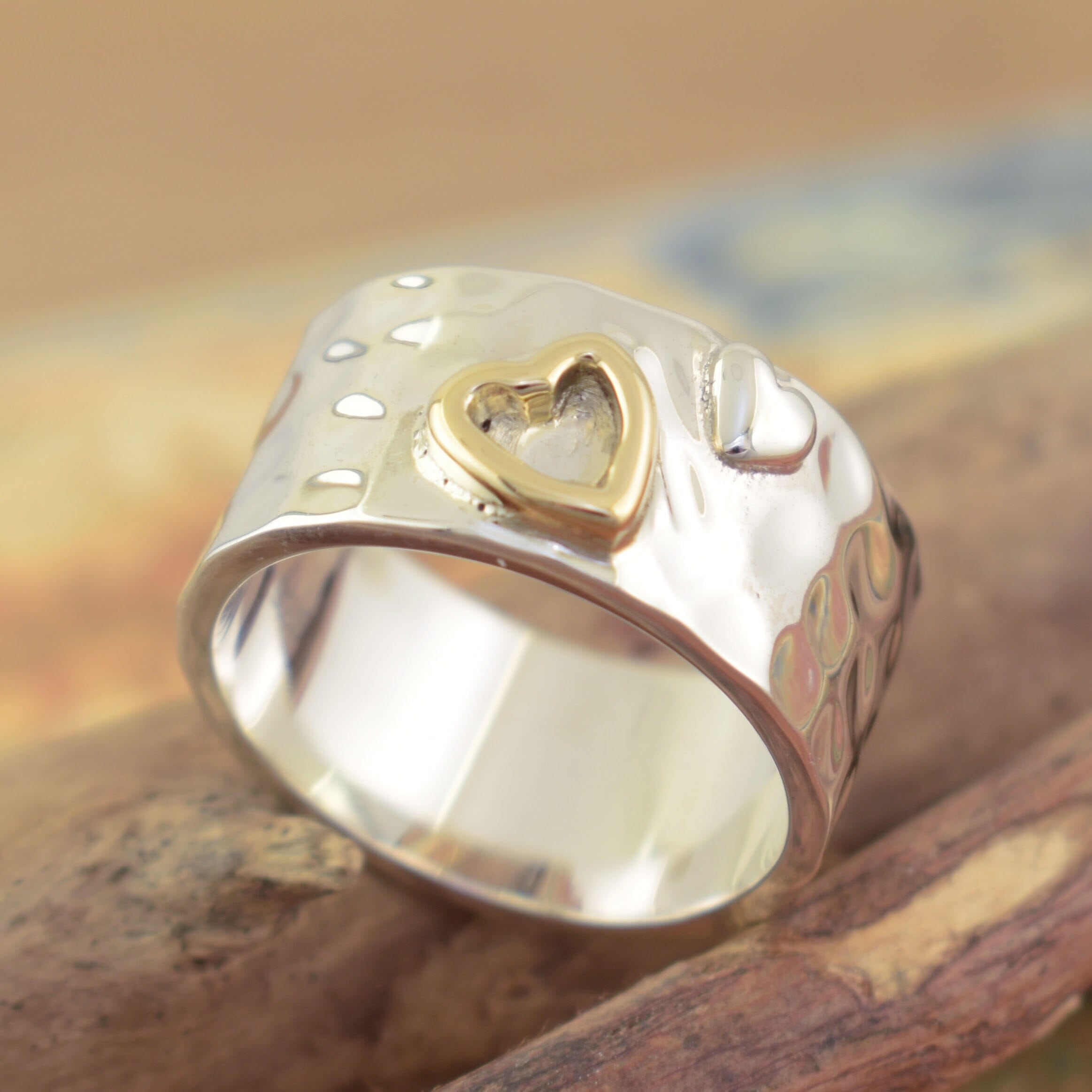 sterling silver with a detailed brass plated heart